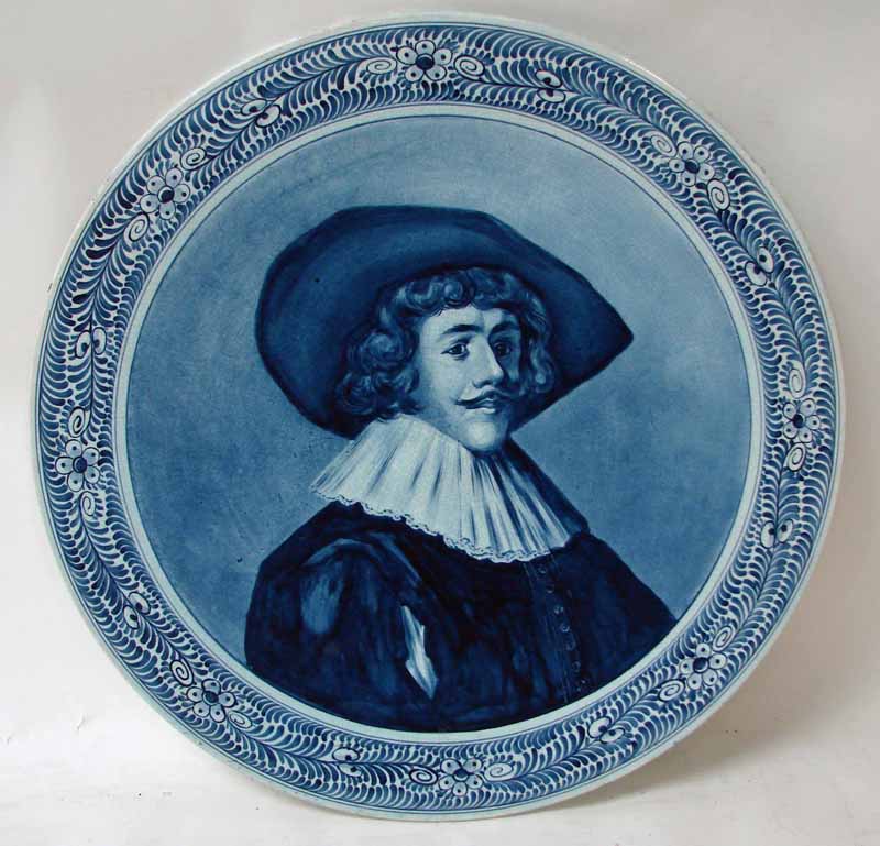 A 19th century Delft charger, of circular form, typically decorated in shades of blue with a