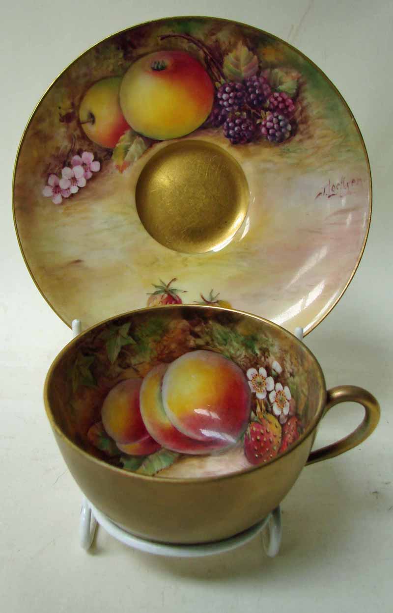 A Royal Worcester duo, consisting of a cup and saucer, both internally hand painted with fruit and