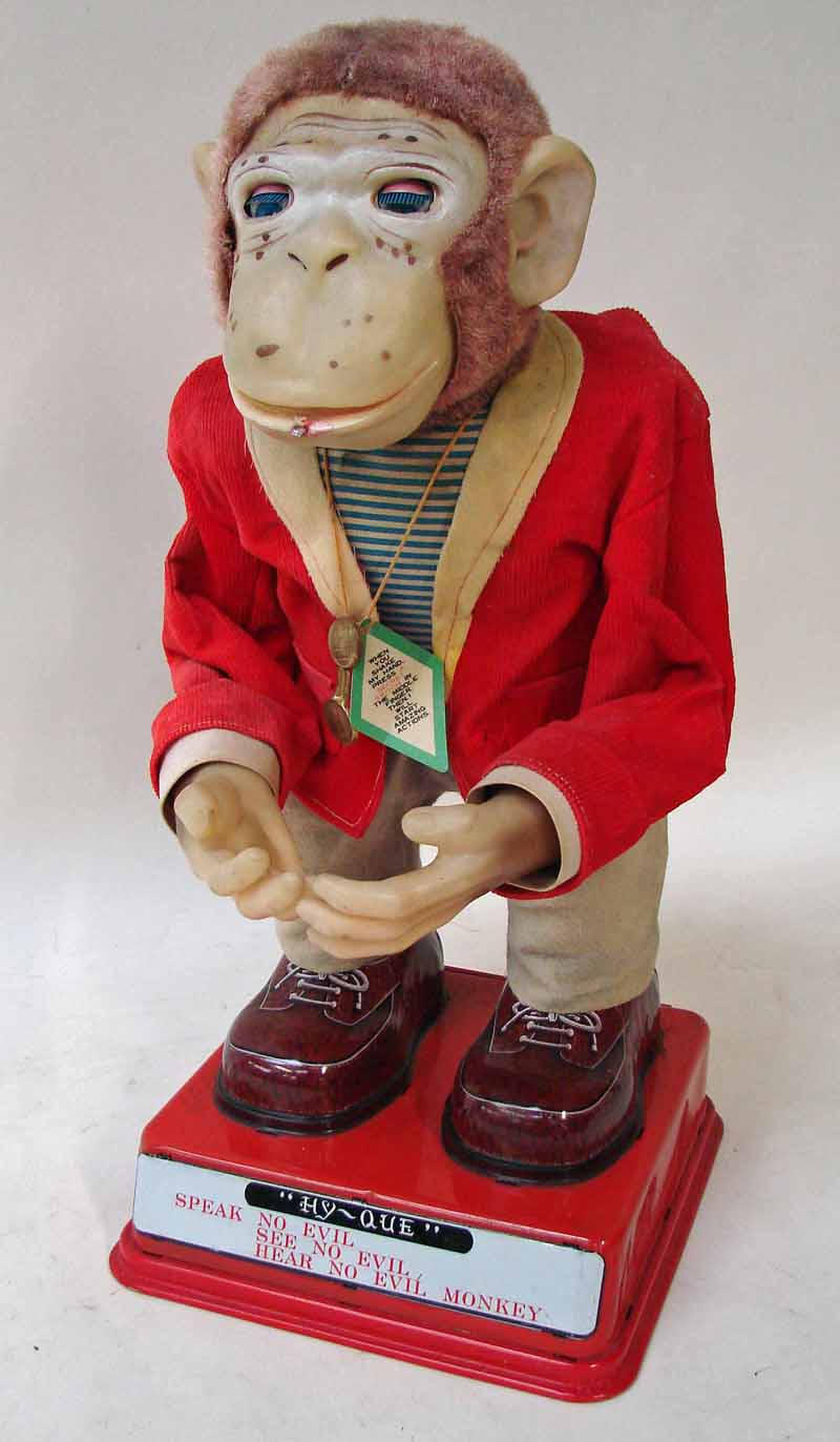 Hy-Que, a Rosko Japanese novelty tinplate and fabric battery operated automated monkey in a red