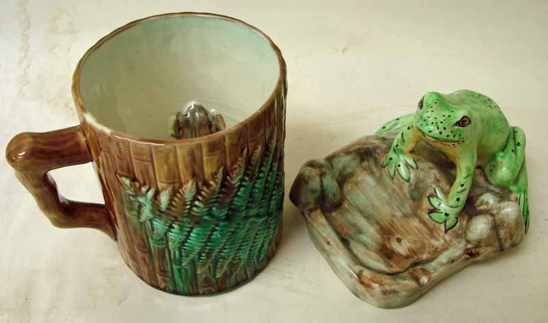 A Victorian majolica frog mug of straight sided form, moulded in relief with fern fronds, on bamboo