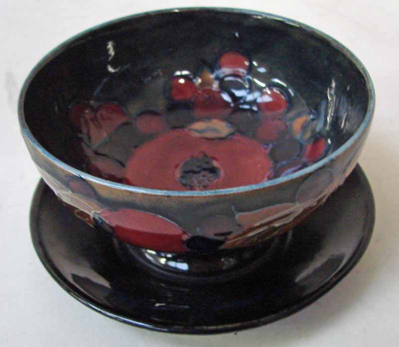 A William Moorcroft grapefruit bowl and integral stand, decorated in the Pomegranate design with