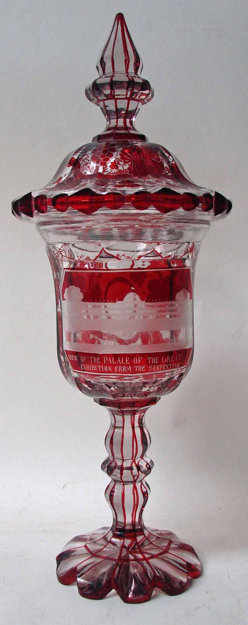 A large 19th century Bohemian cut glass goblet and cover, ruby flashed with fruiting vine