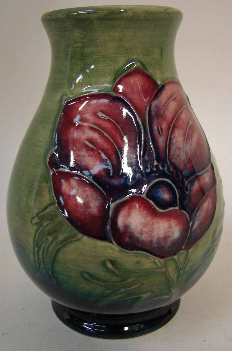 A Moorcroft pottery small vase of baluster form, tubeline decorated in the Anemone design on a