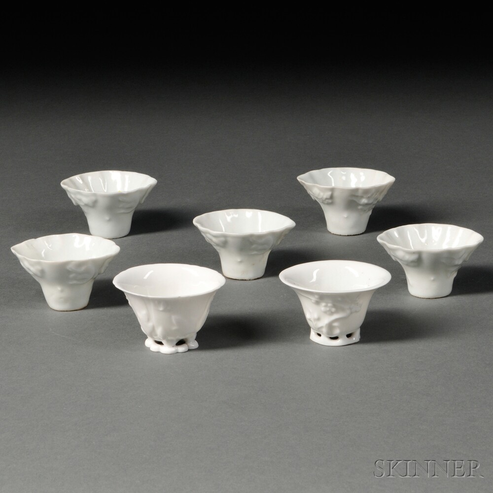 Seven Blanc-de-Chine Cups, China, Qing Dynasty, five rhinoceros horn cup form, molded in high