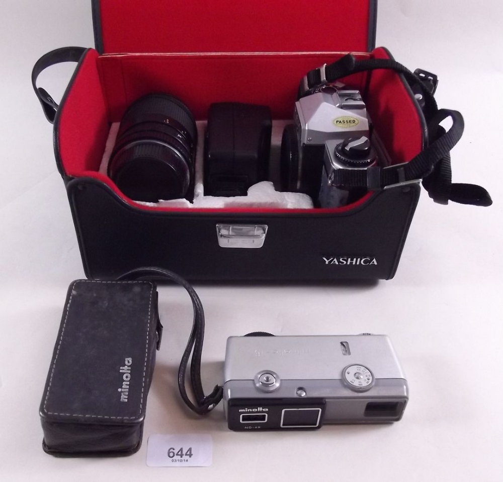 A Yashica camera FX-D and zoom lens and an early Minolta 16 instamatic with leather case and hand