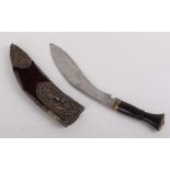 Indian Kukri, 11 ins blade, brass mounted ebonised grip in relief decorated filigree and feather