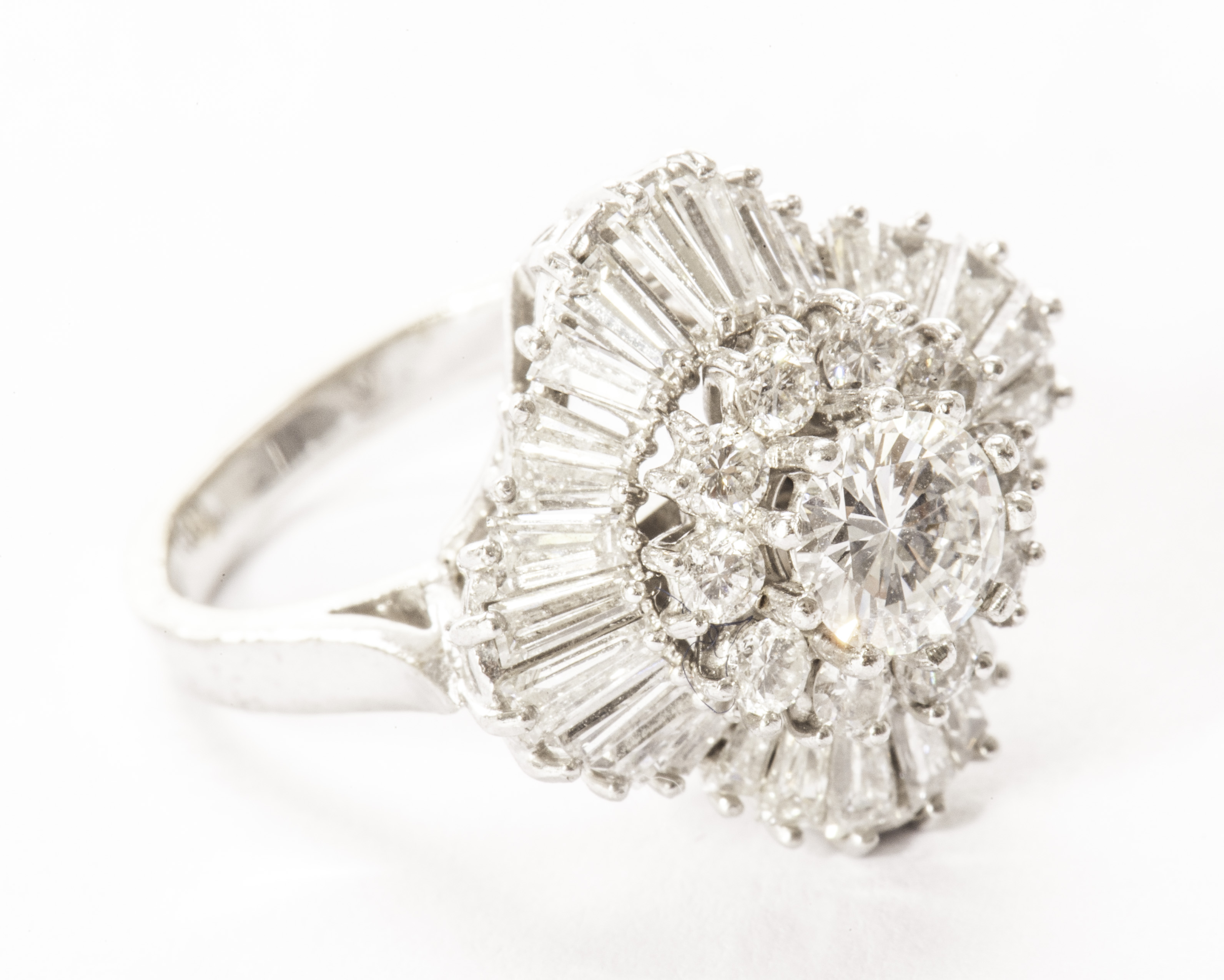 An impressive diamond cluster style dress ring, having a central brilliant cut of approx 0.75ct