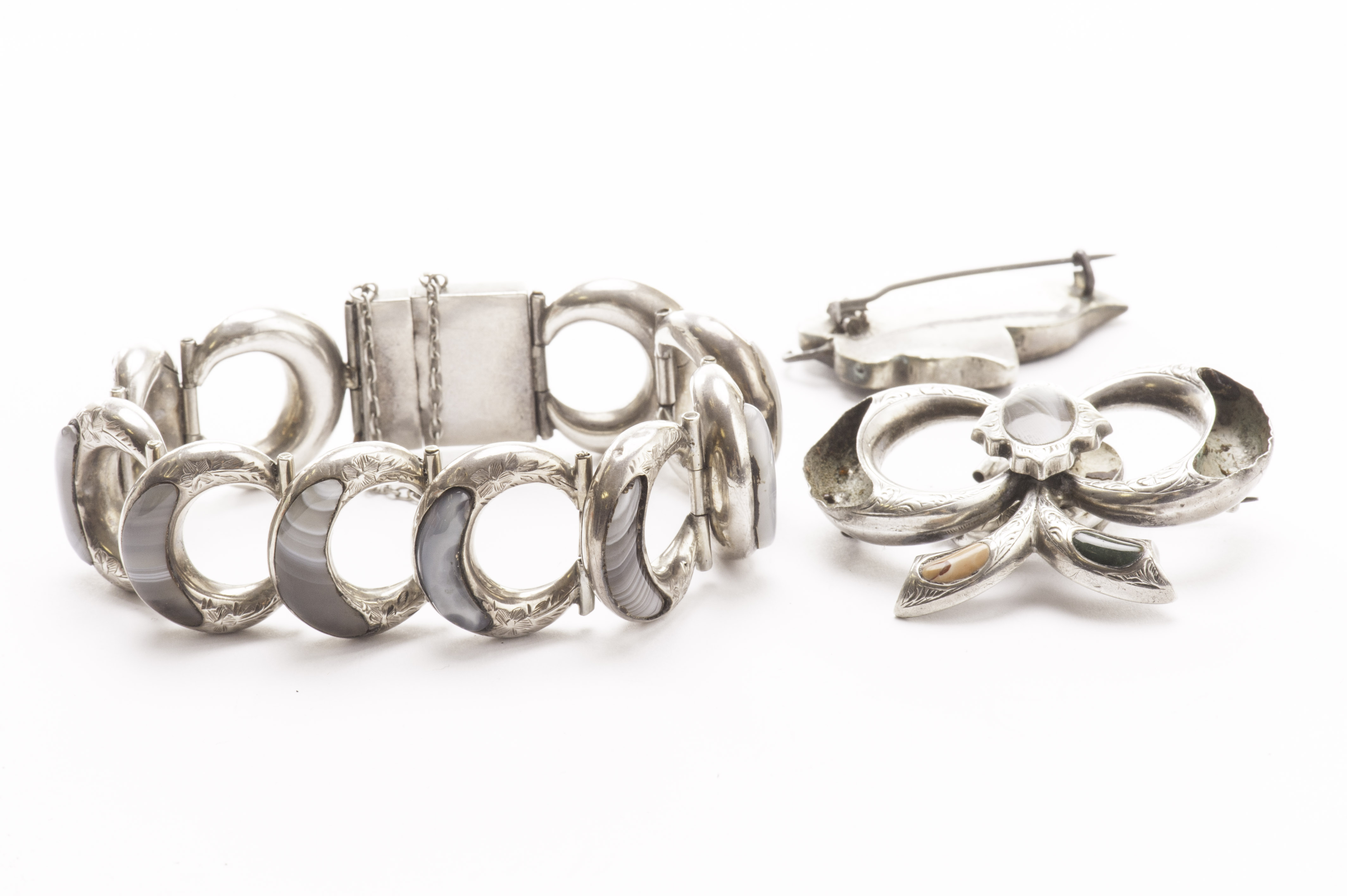 A Scottish silver and agate bracelet, the semi-circular engraved links set with a polished