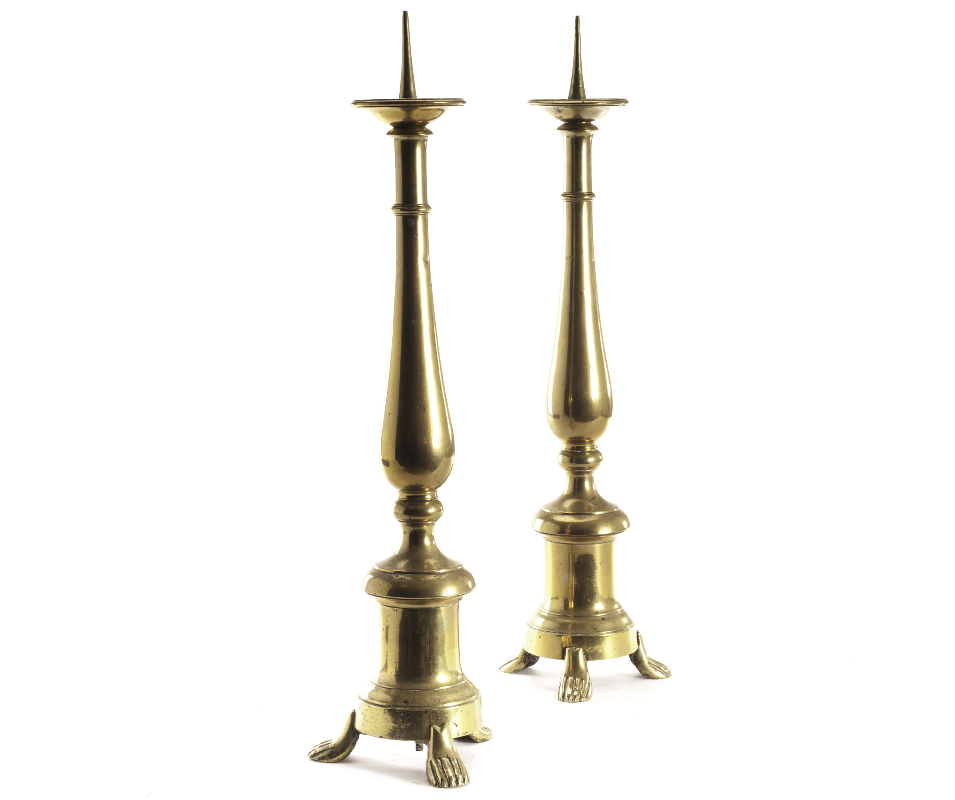 A pair of large brass church candlesticks, having drip tray and spikes above inverted baluster