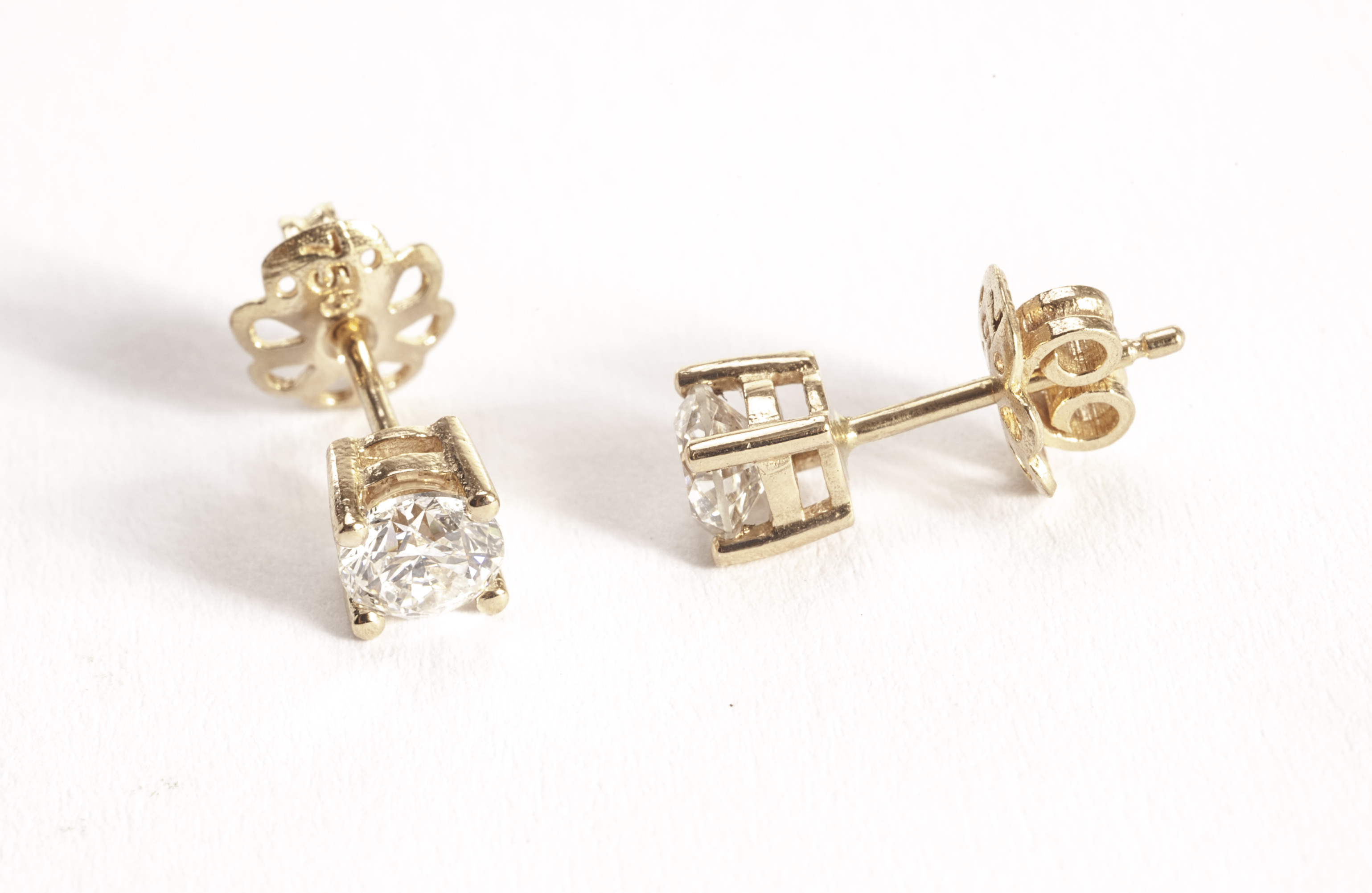 A pair of diamond stud earrings, each earring having an approx 0.5ct brilliant cut in four claw