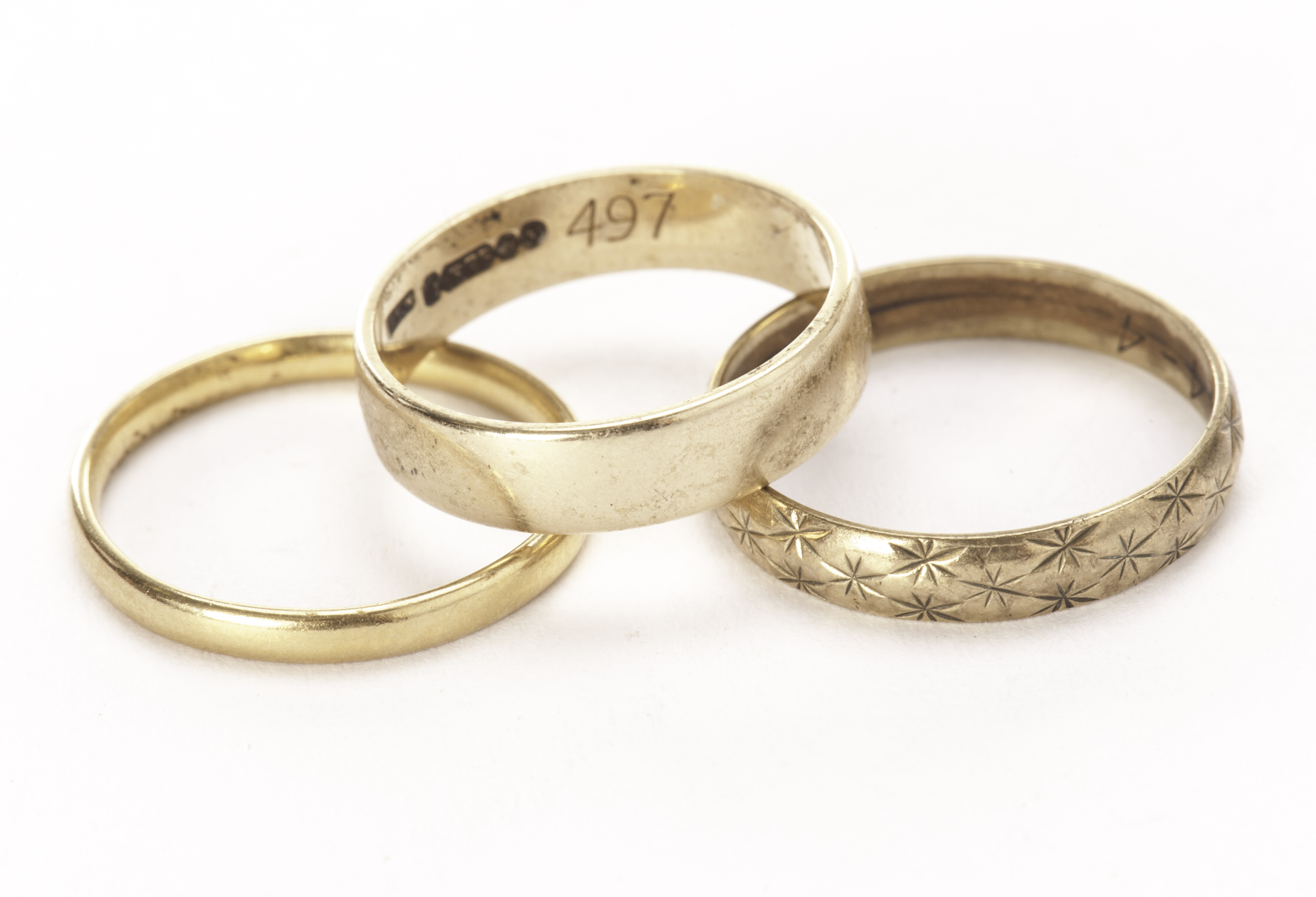 Three gold wedding bands, including a plain 22ct gold ring, a plain 9ct gold example and an