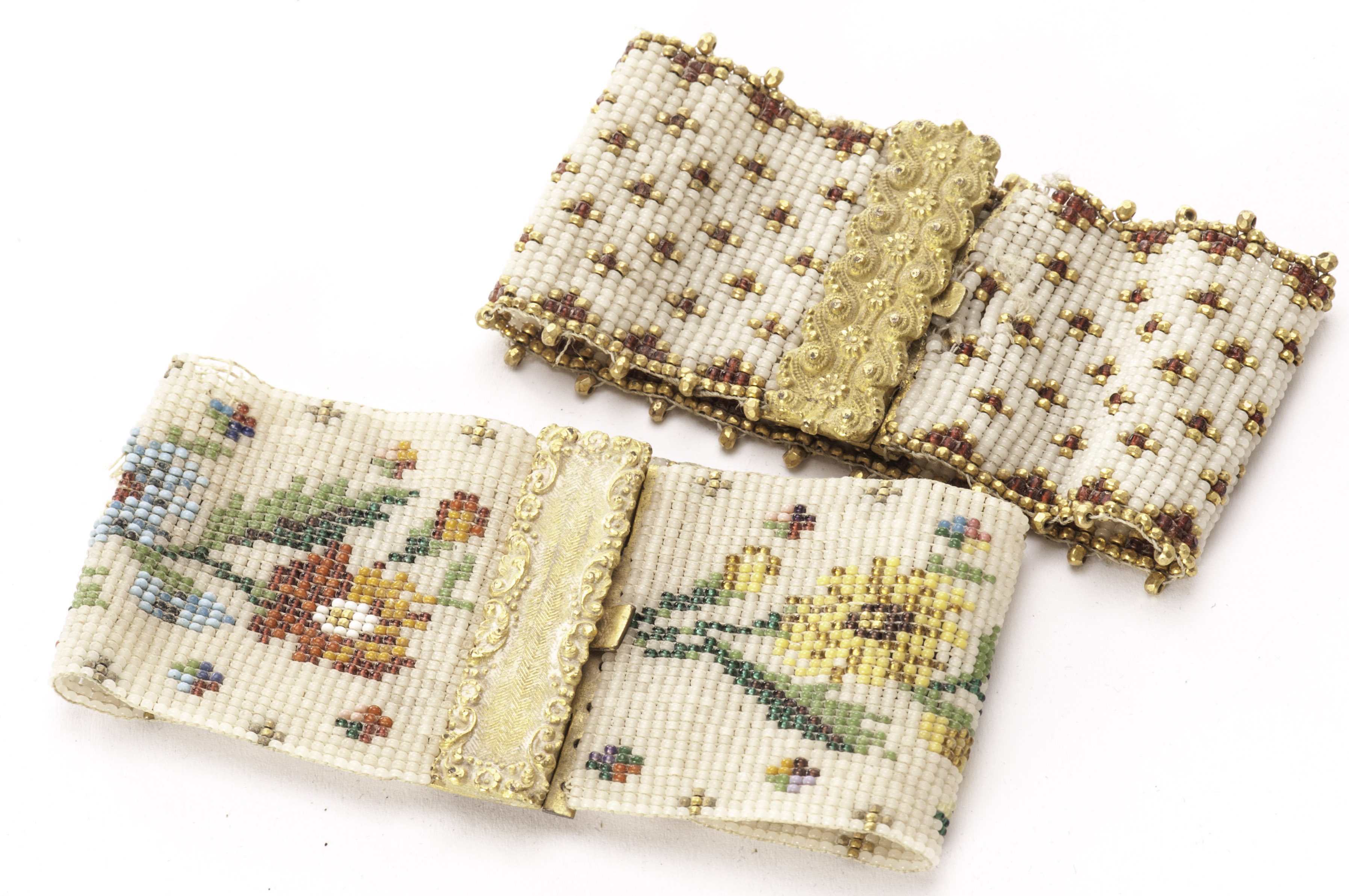 Two 19th century beadwork cuff bracelets, one with floral design and gilt clasp, the other with