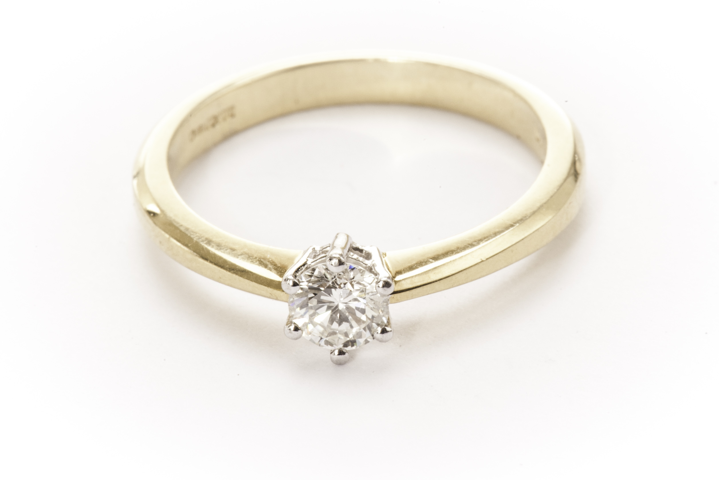 A modern diamond solitaire engagement ring, the approx 0.3ct brilliant cut in white claws on an