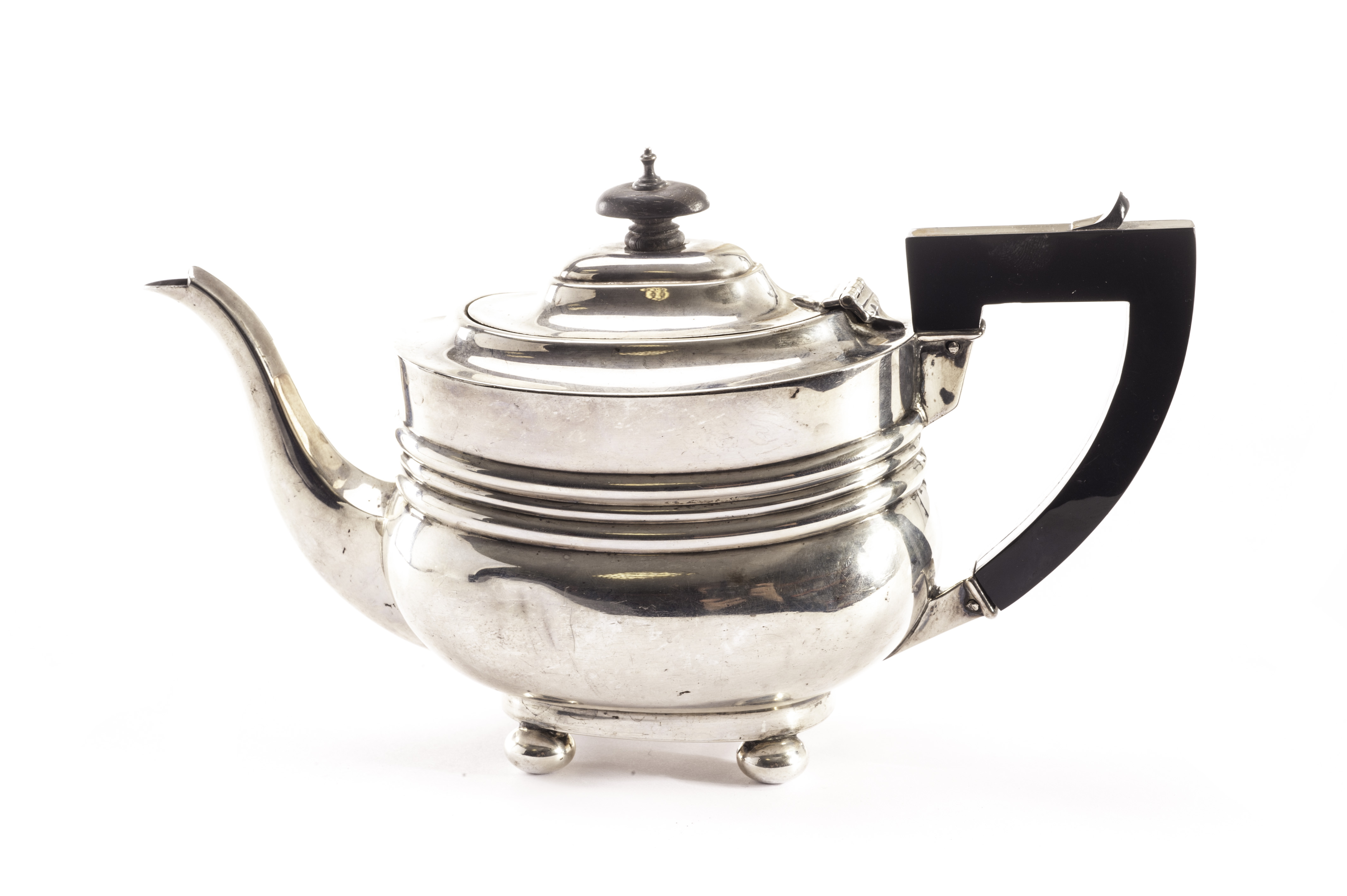 An Edward VII silver bachelors teapot from Ollivant & Botsford, the plain form with three raised