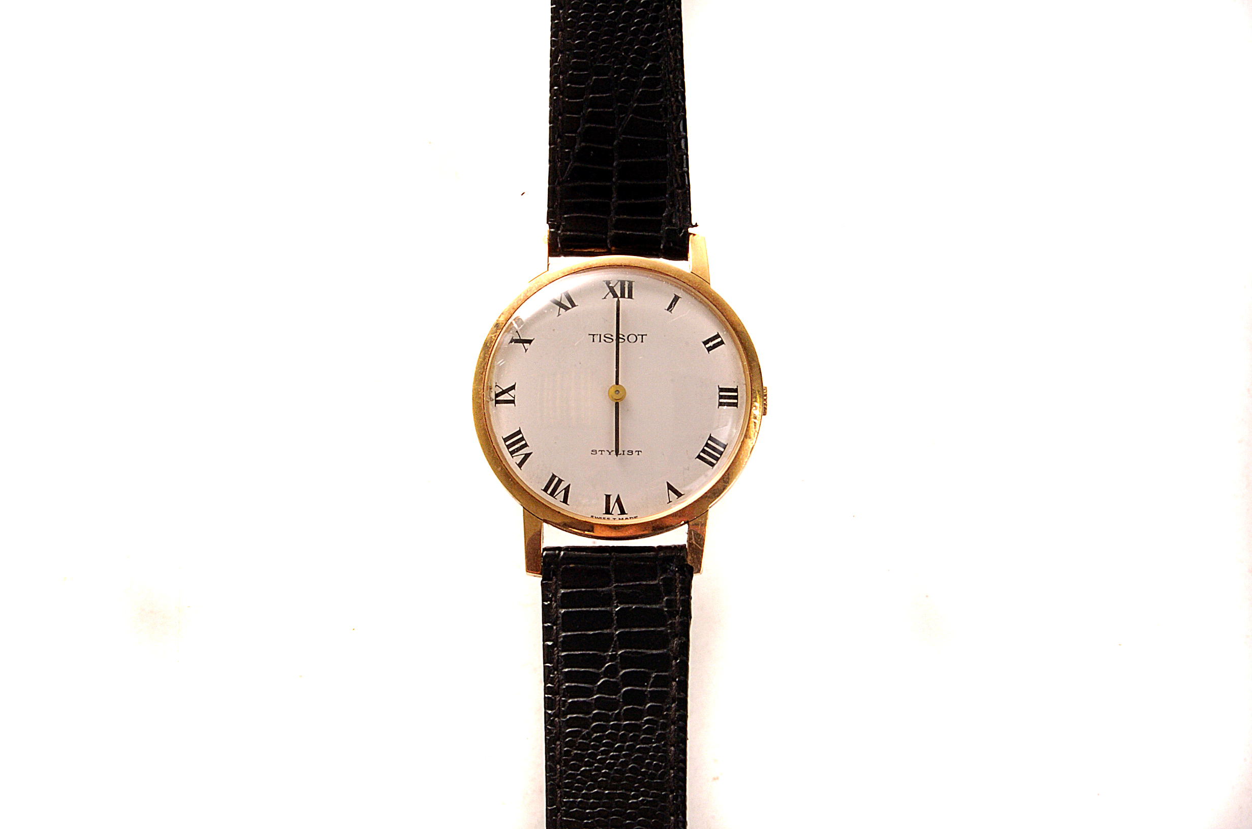 A 9ct gold cased Tissot gent`s wristwatch, with white face and black Roman numerals, on black