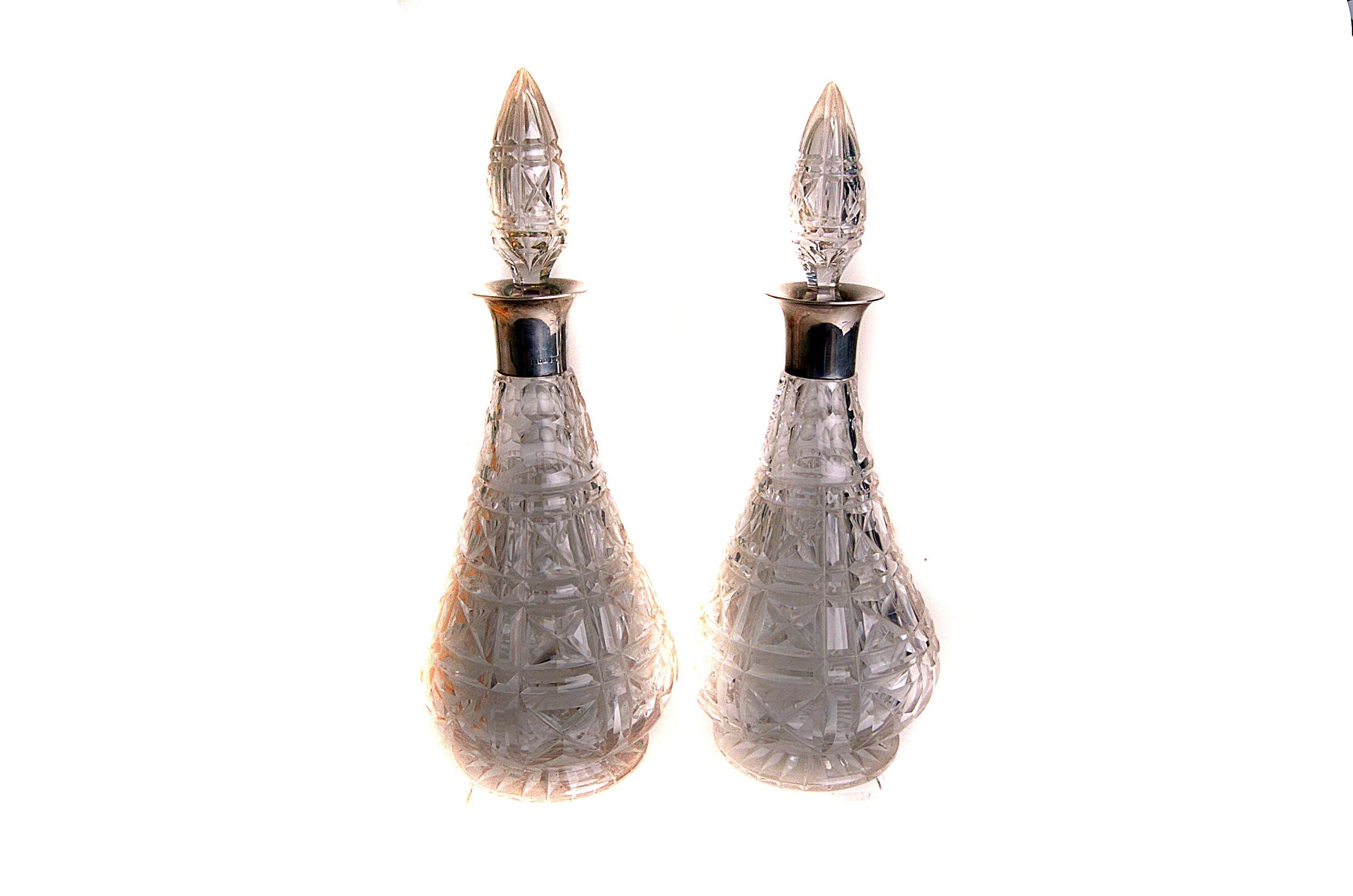 A pair of Edward VII silver necked lead crystal decanters and stoppers, marked London 1908,