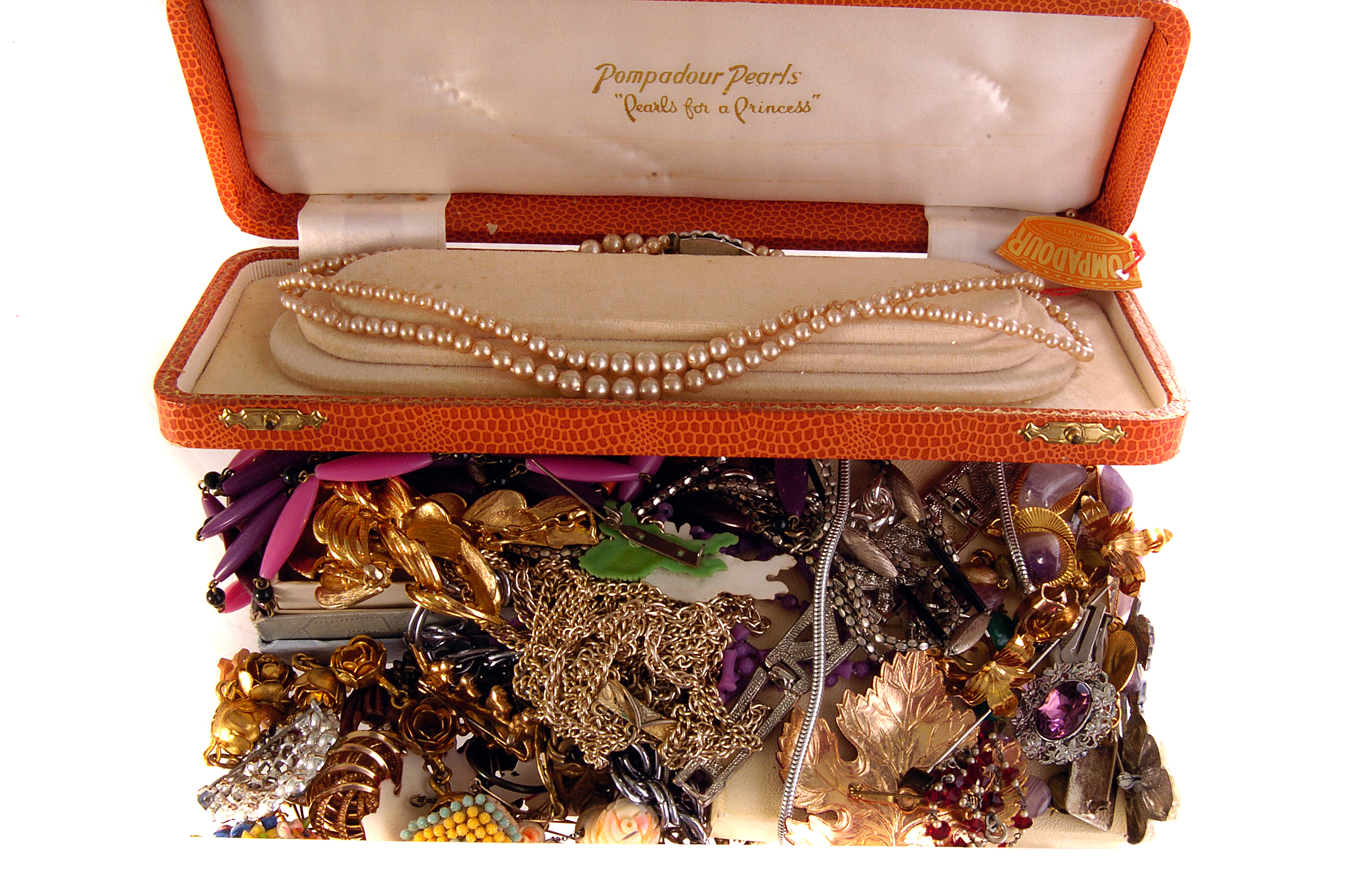 An assortment of costume jewellery, comprising necklaces, brooches, simulated pearls and more (