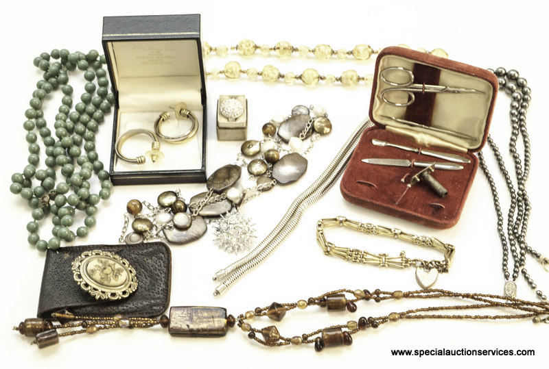 An assortment of costume jewellery, including an ivory necklace, mother of pearl necklace, white