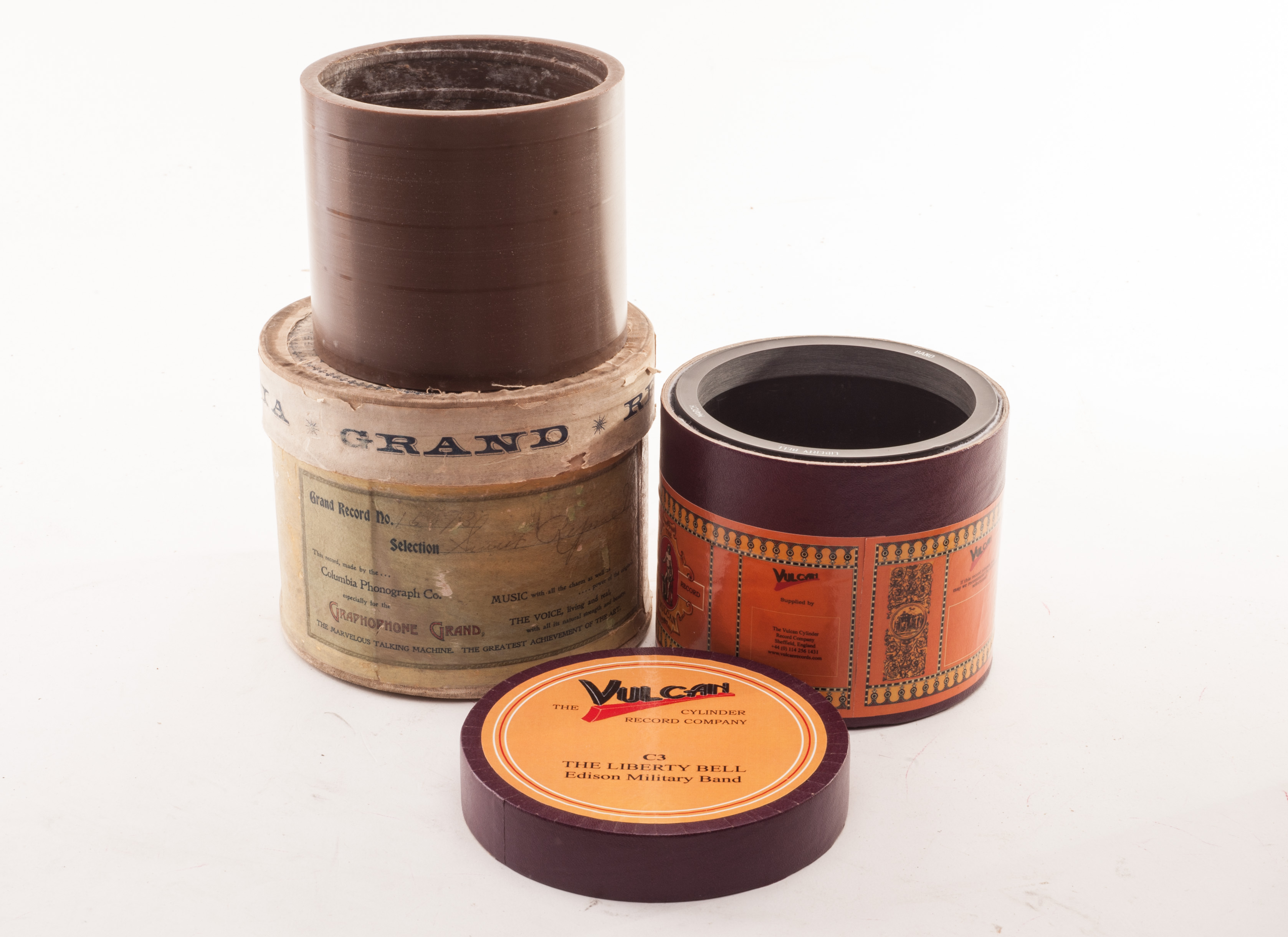 Concert cylinders: a brown wax cylinder with three/four tracks, in Columbia carton; and a Vulcan