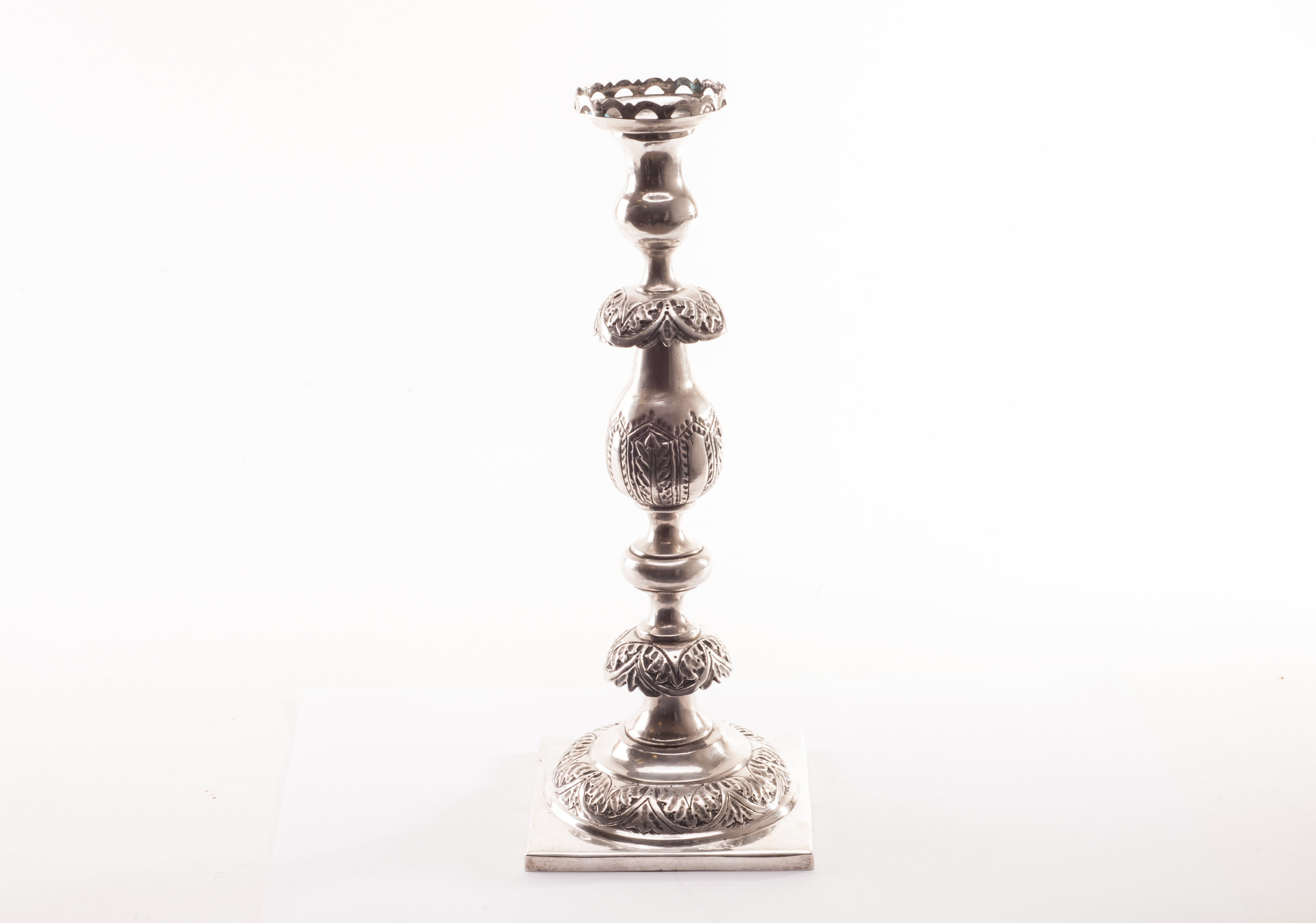A Victorian silver candlestick from MF, square foot with domed support having several knops to