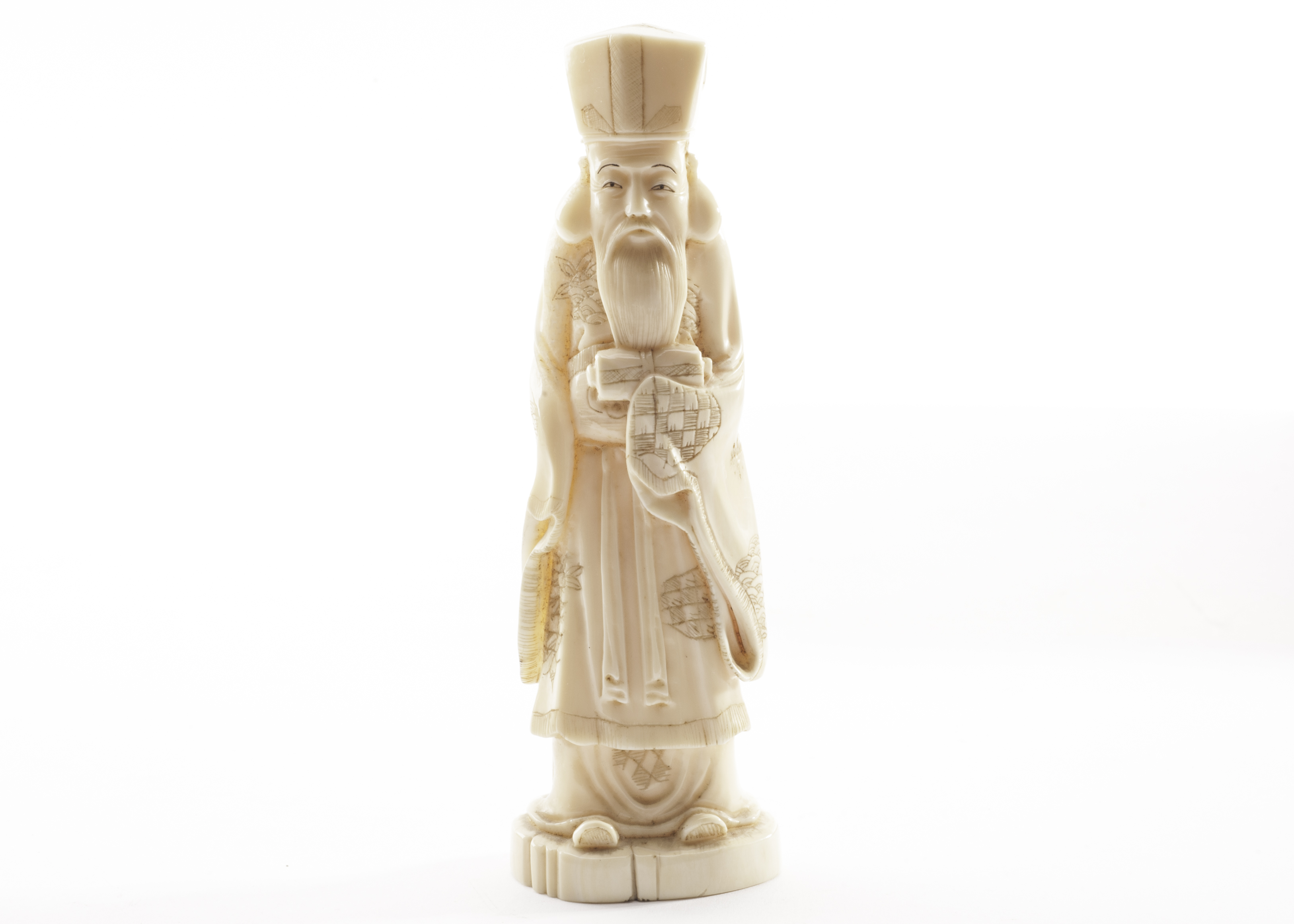 A late Meiji period Japanese carved ivory figure, modelled as an immortal in traditional robes