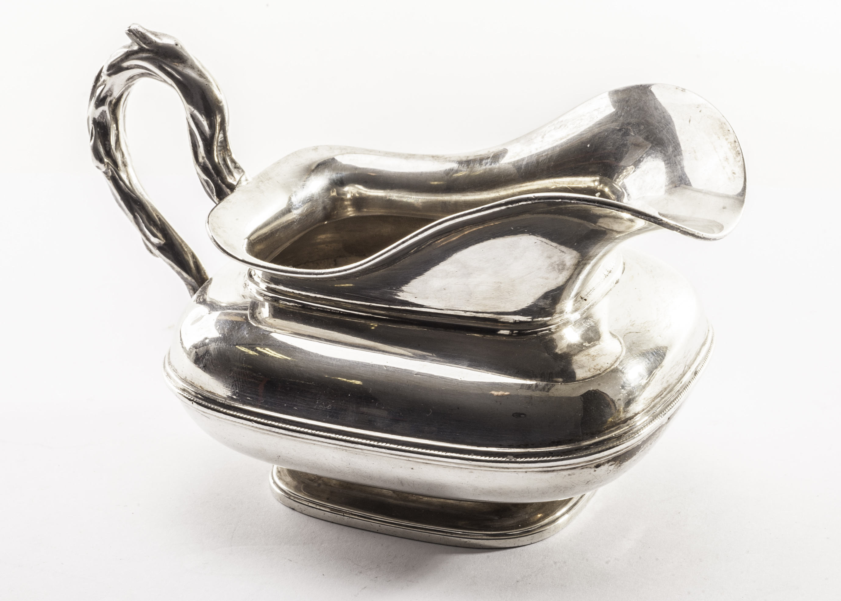 An continental silver jug, possibly Italian, the squat form with applied branch style handle,