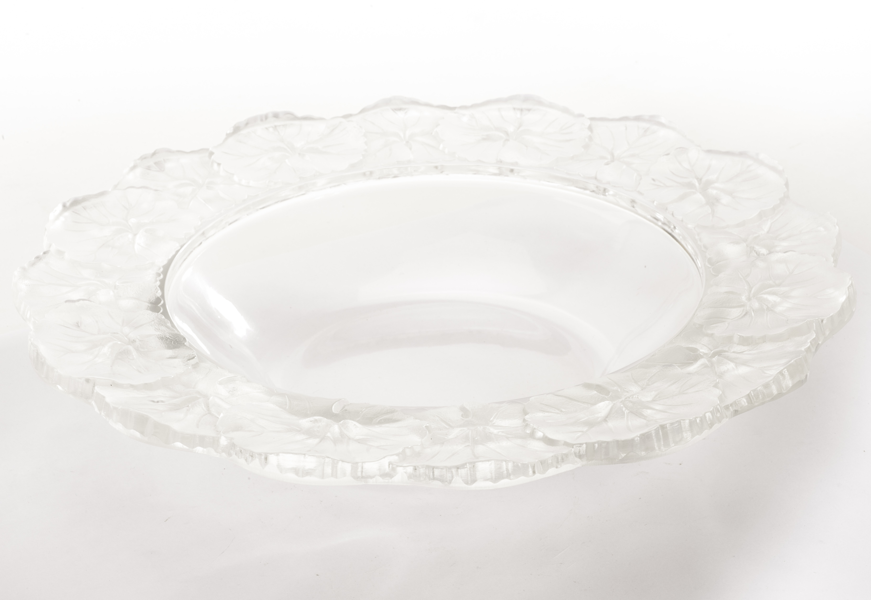 A modern Lalique glass Honfleur pattern bowl, the circular form with raised leaf design to rim and