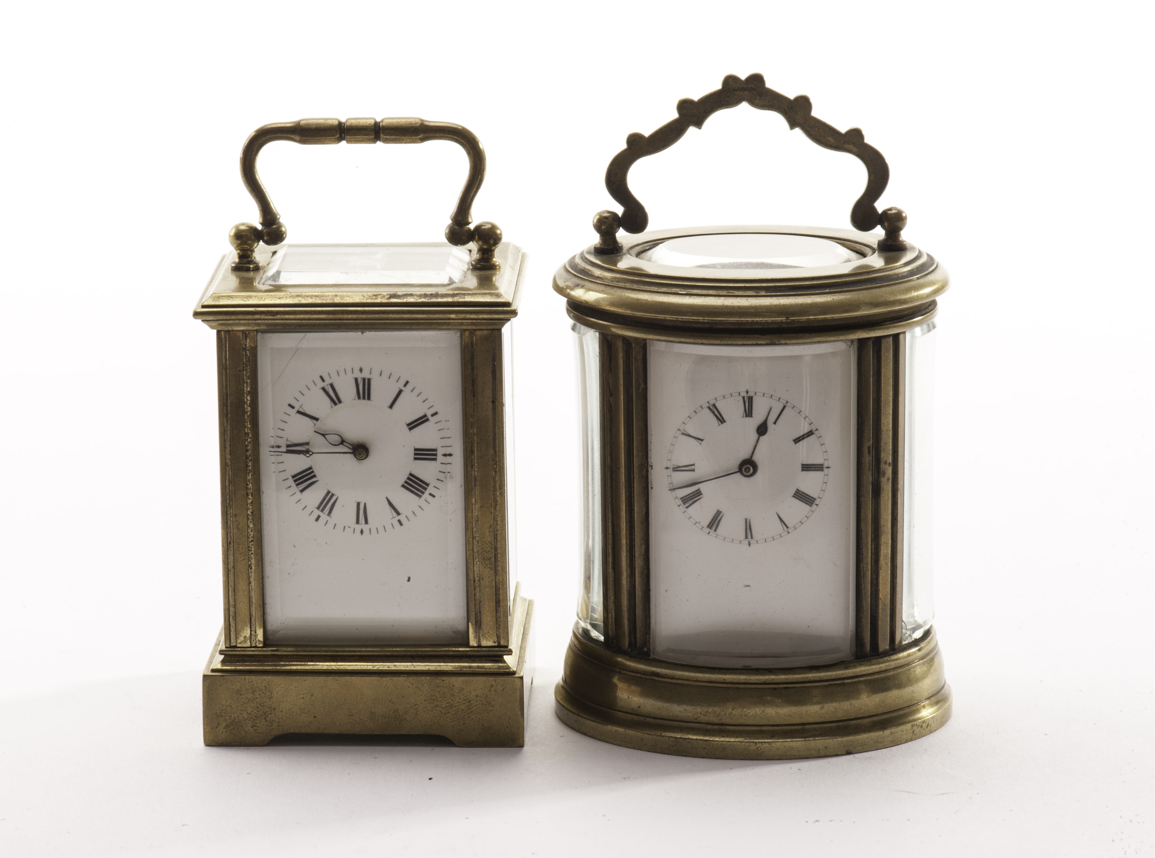 Two minitaure brass carriage timepieces, one traditional form with arch lever escapement, the other