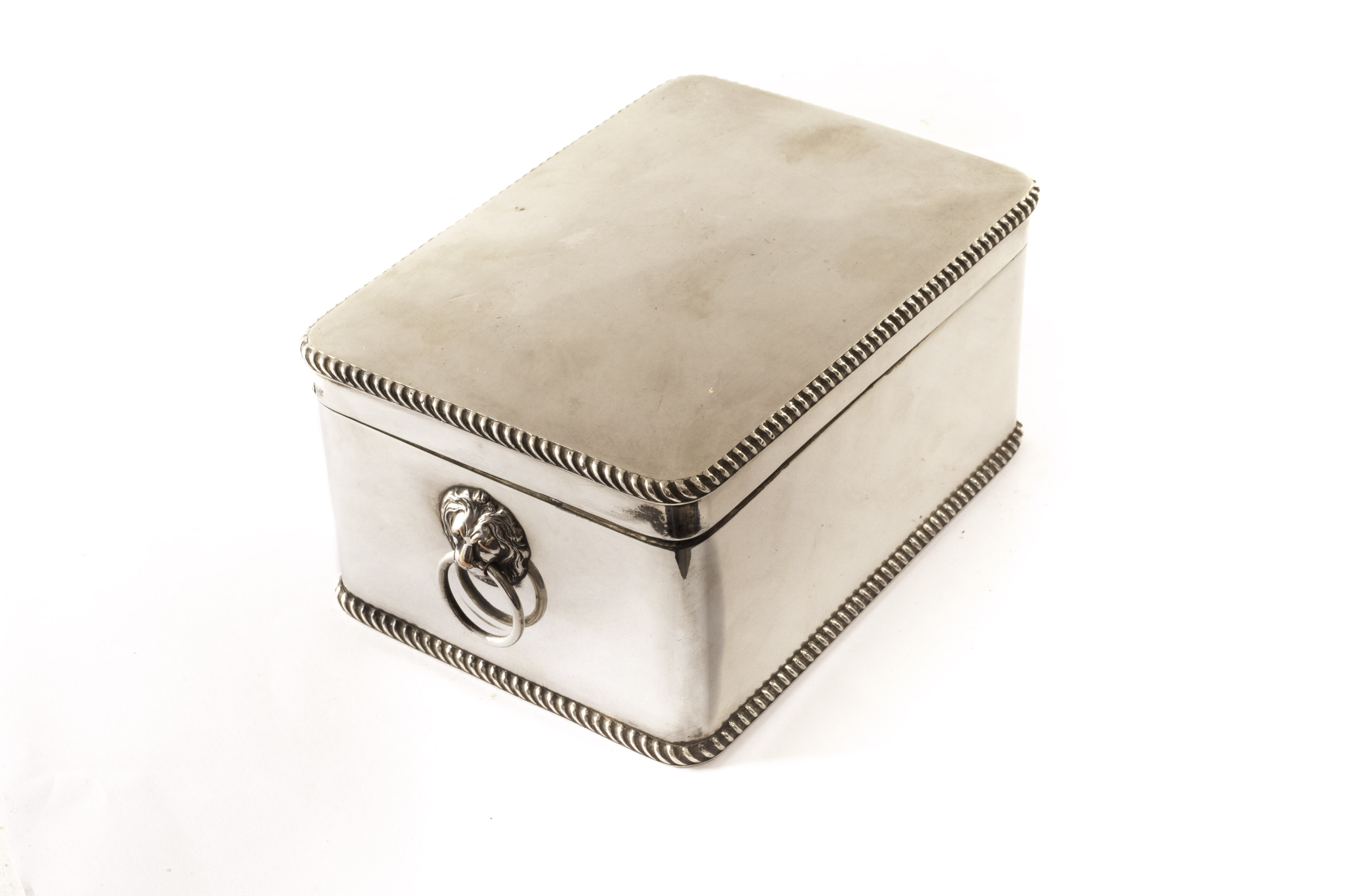 A good quality Sheffield plate cigarette or desk box, rectangular with twin lion head and loop