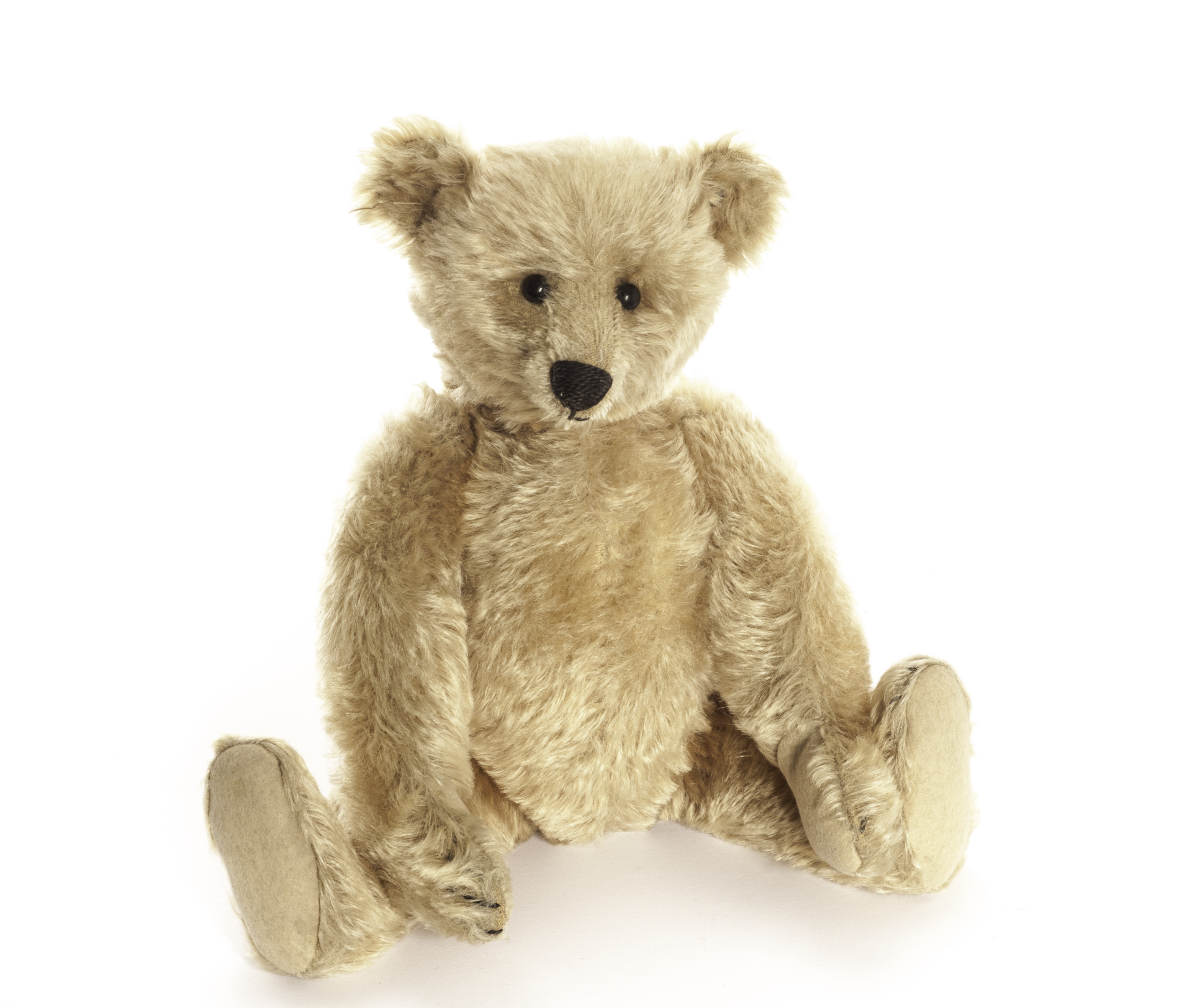 A Steiff Teddy Bear, circa 1908, with golden mohair, black boot button eyes, pronounced clipped