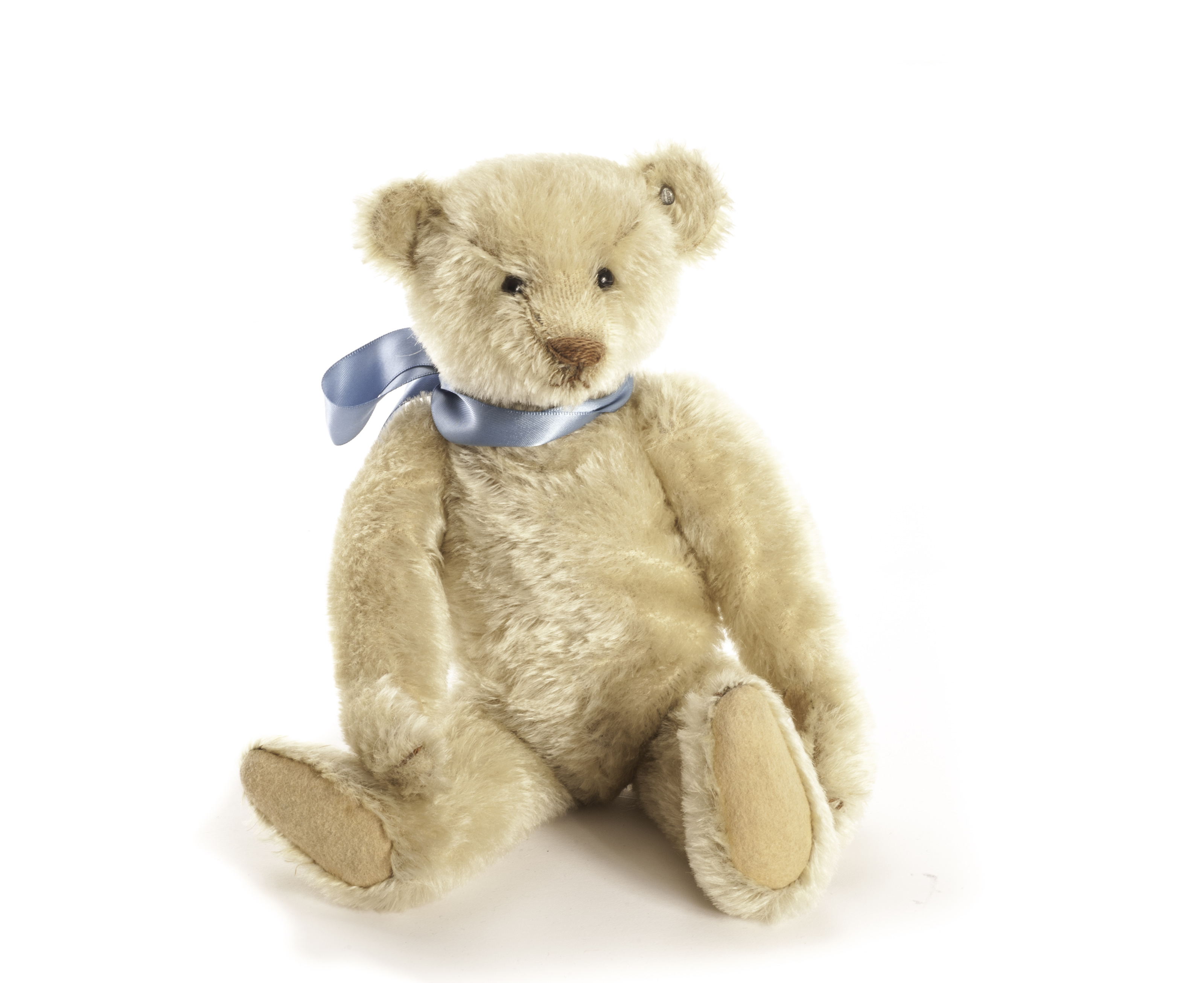 A Steiff white mohair Teddy Bear, circa 1906, with black boot button eyes, pronounced clipped