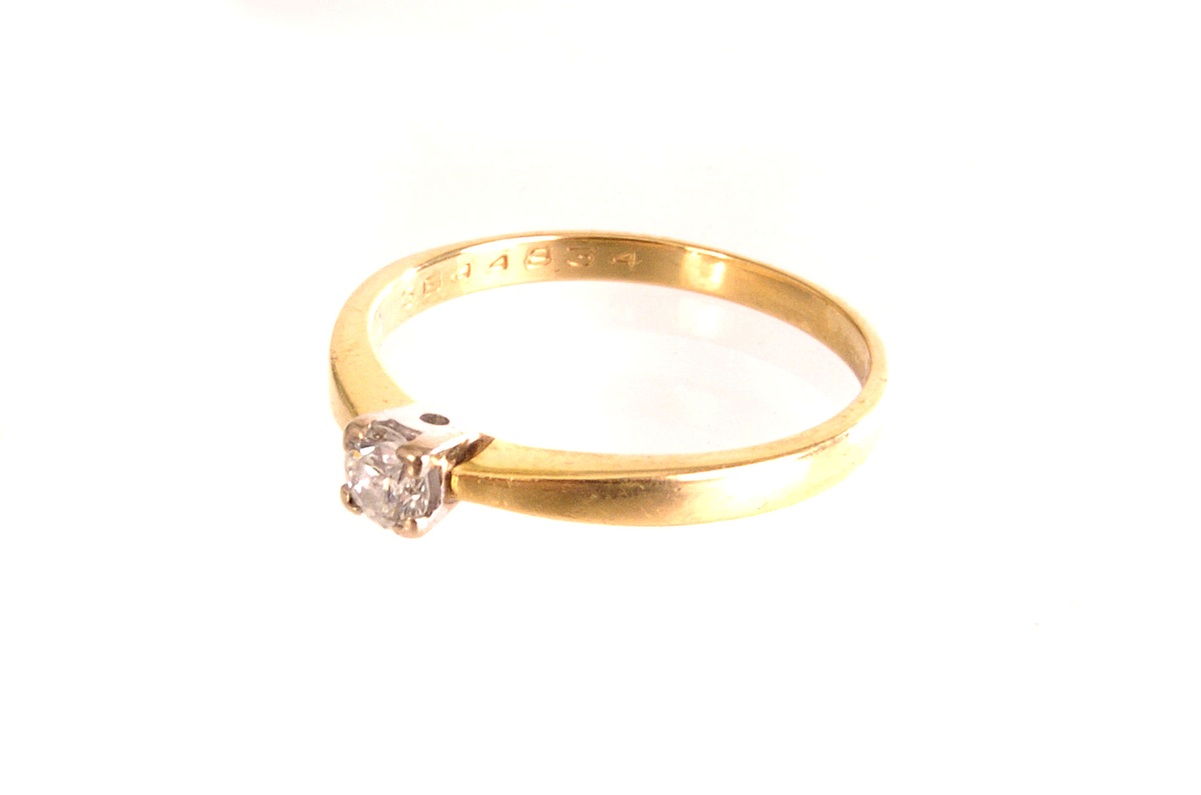 A diamond solitaire engagement ring, the 0.25ct brilliant cut in 18ct gold mount, sold with an IGI