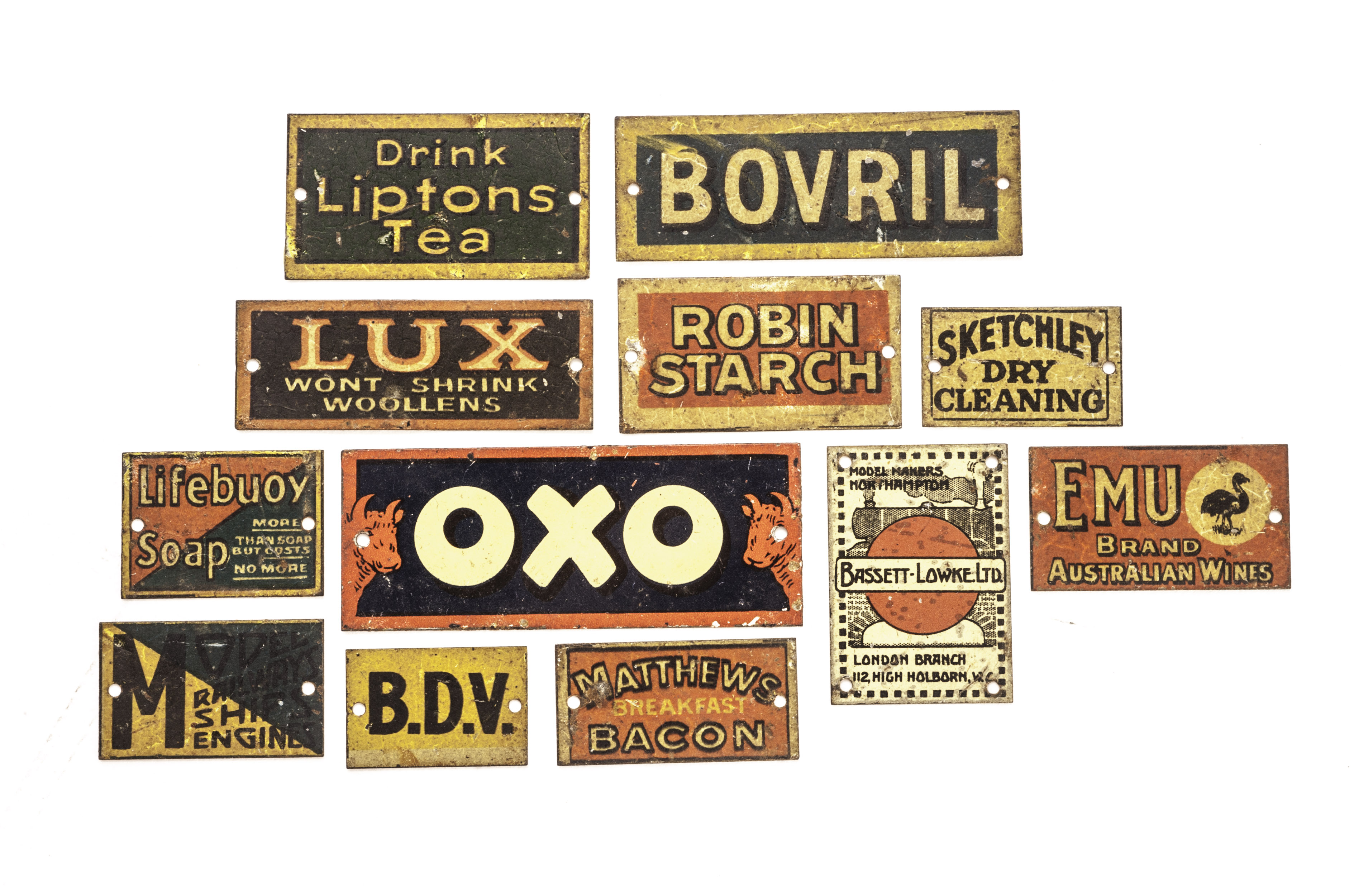 A collection of Bassett-Lowke and others 0 Gauge tin signs: including Bassett-Lowke, OXO, Liptons