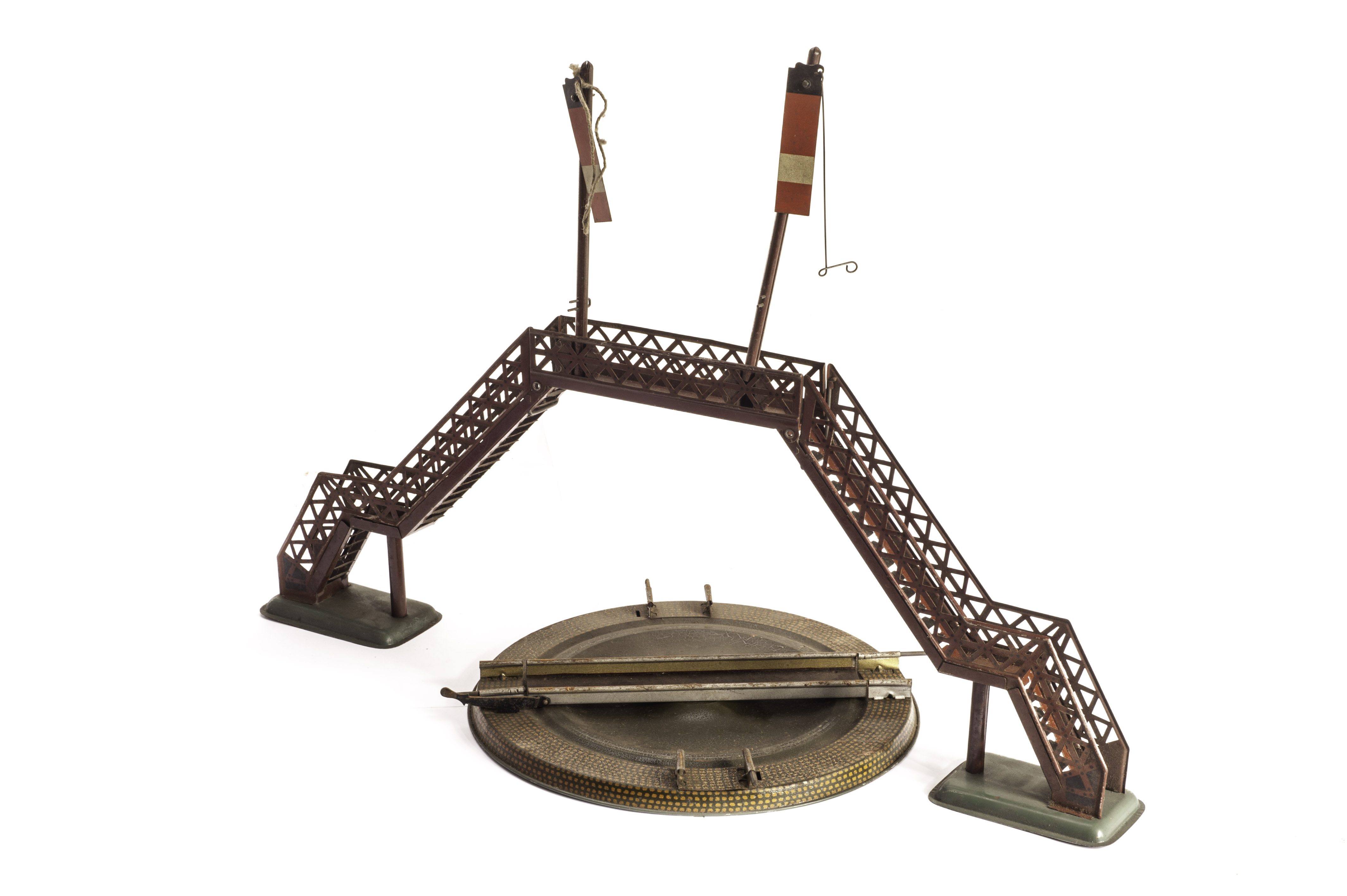 A pair of Bing 0 Gauge Footbridges with signals, in tuscan red with grey rivet dots and grey bases,