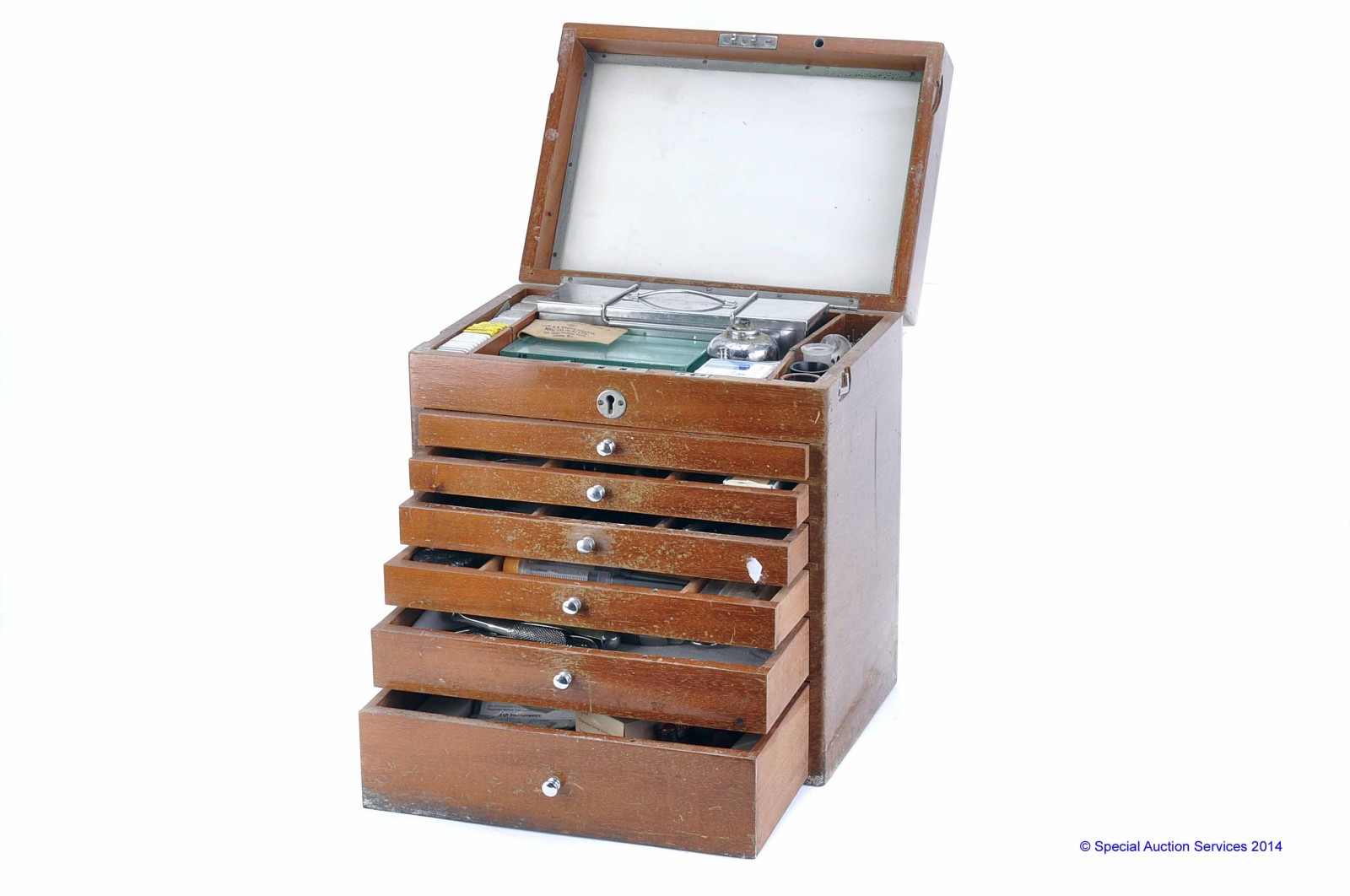 A Wooden Dental Seven-Drawer Instrument Cabinet, sterilisable instruments, including mirrors,