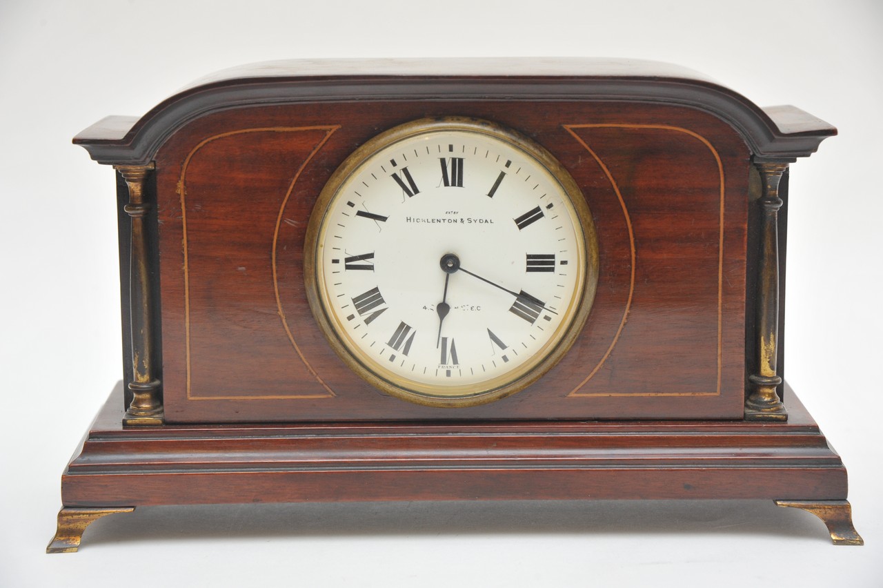 A small edwardian inlaid mantel clock the enamel dial with Roman Numerals