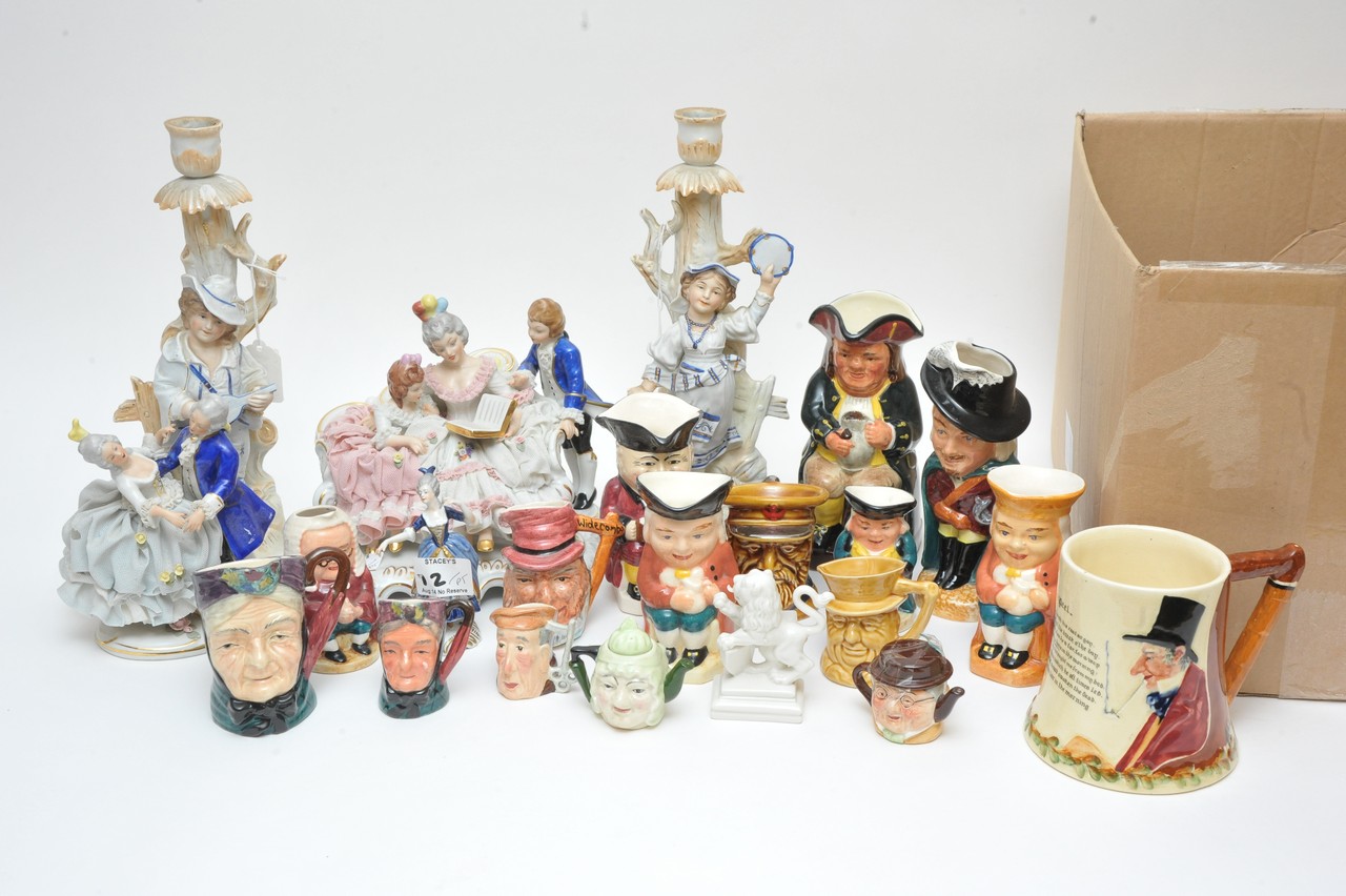 A collection of continental figure groups, candlesticks and box of toby jugs