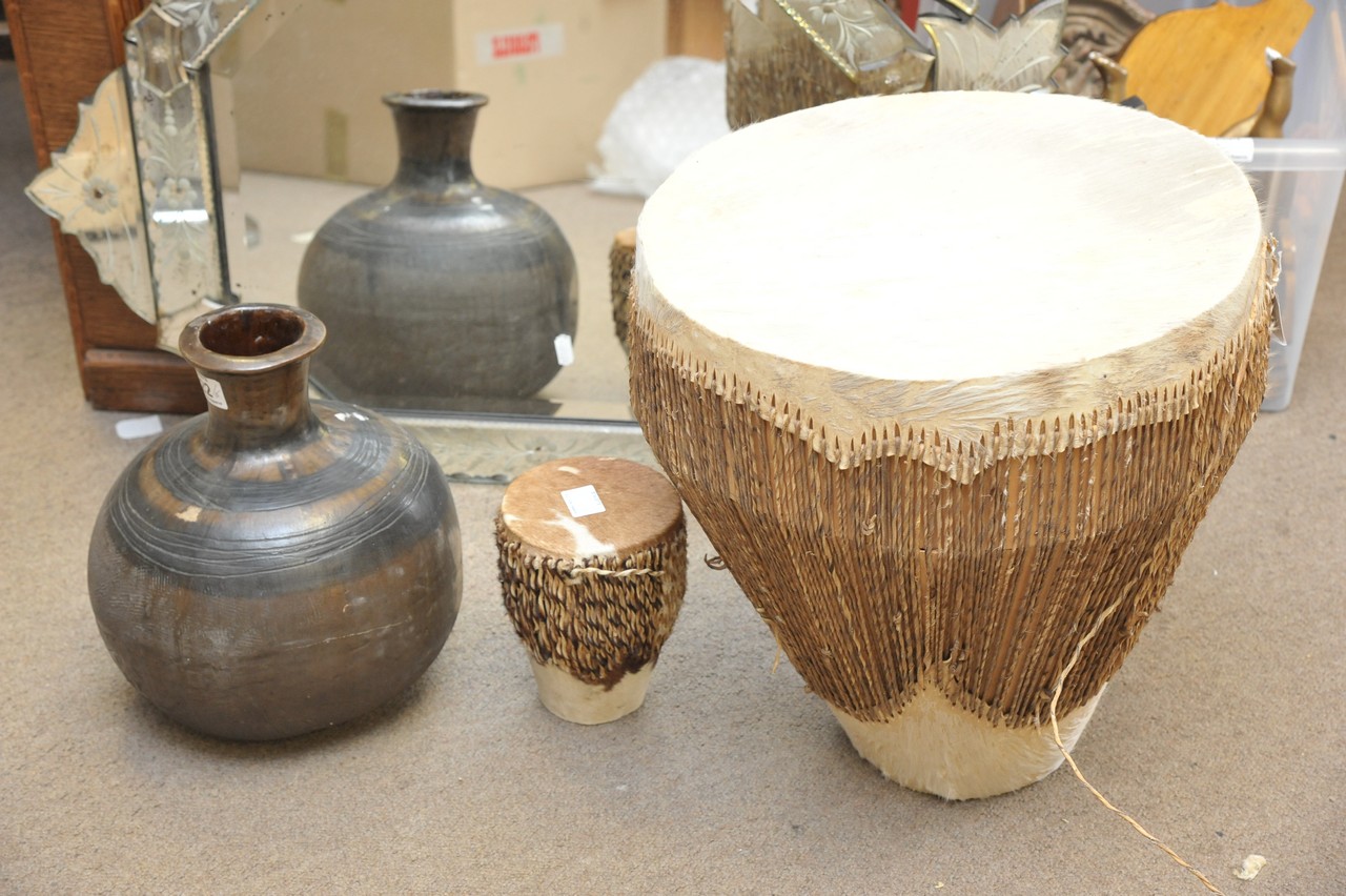 A large tribal pot and two drums