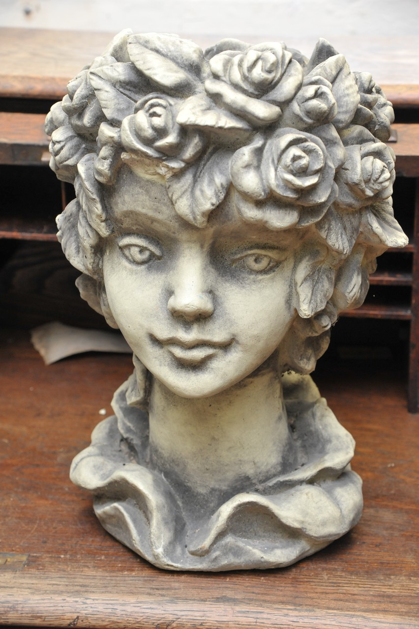 A resin planter formed as a maiden