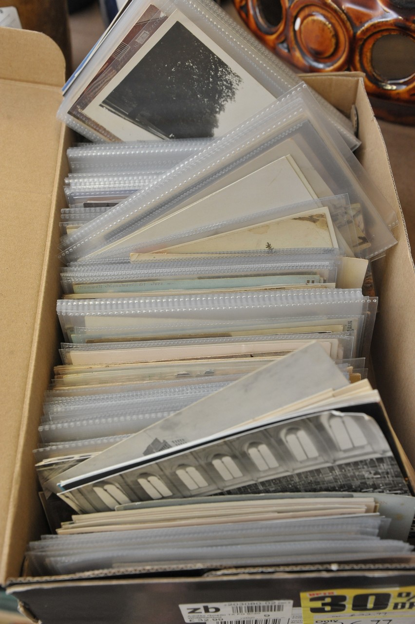 A box of early 20th century postcards