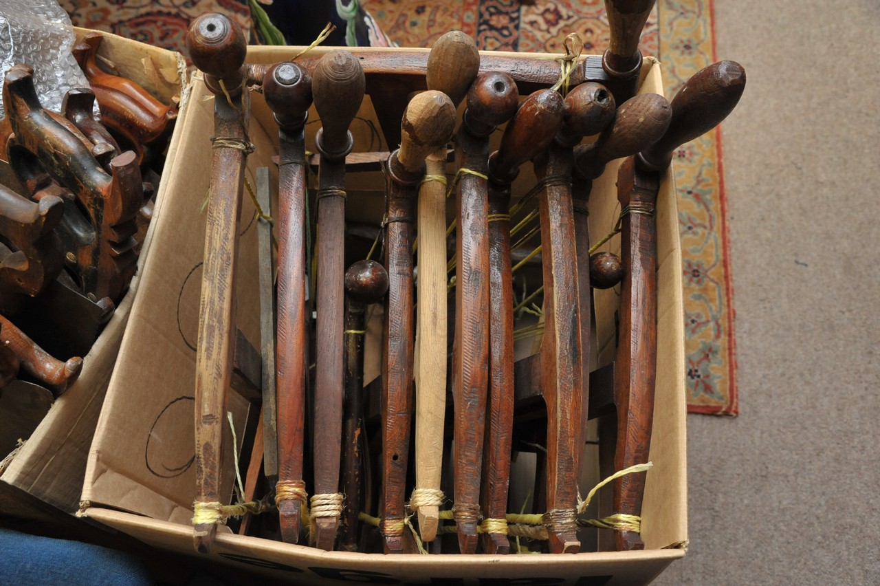 A box containing a large collection of assorted early wooden bow saws