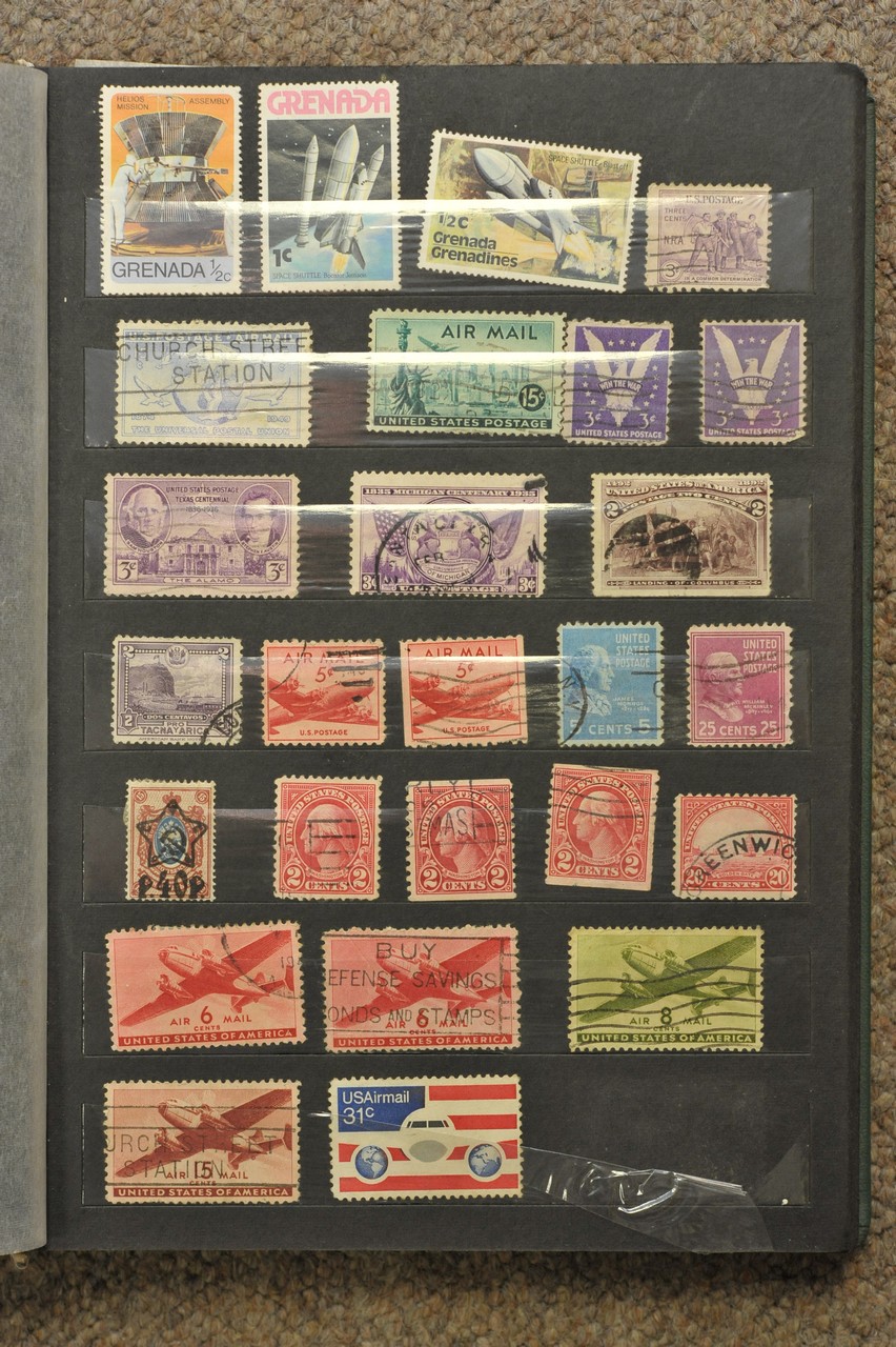 A green stamp album containing World stamps