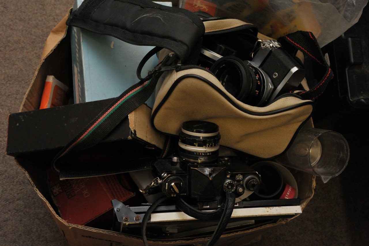 A box of photographic equipment including cameras