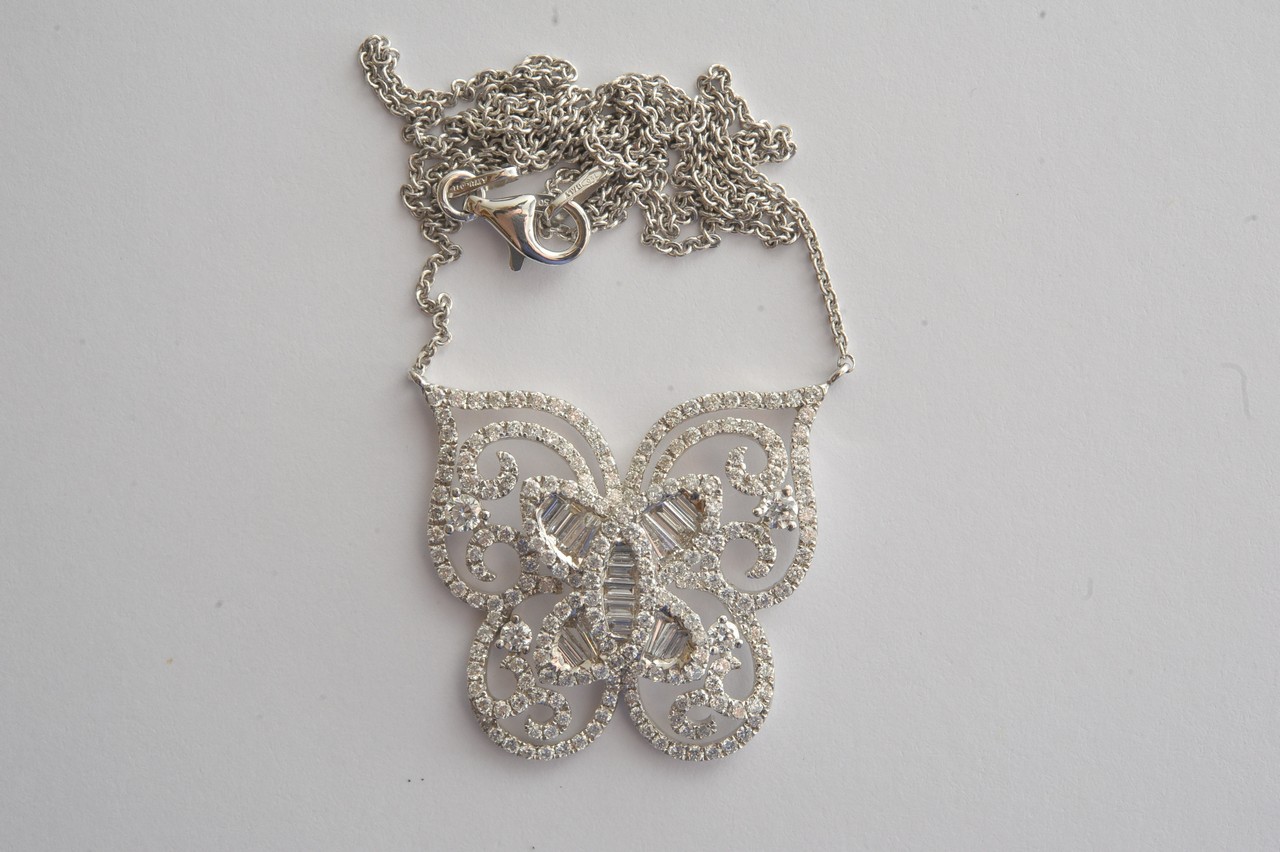 A ladies 18ct white gold pendant on chain in the form of a stylised butterfly set with brilliant and