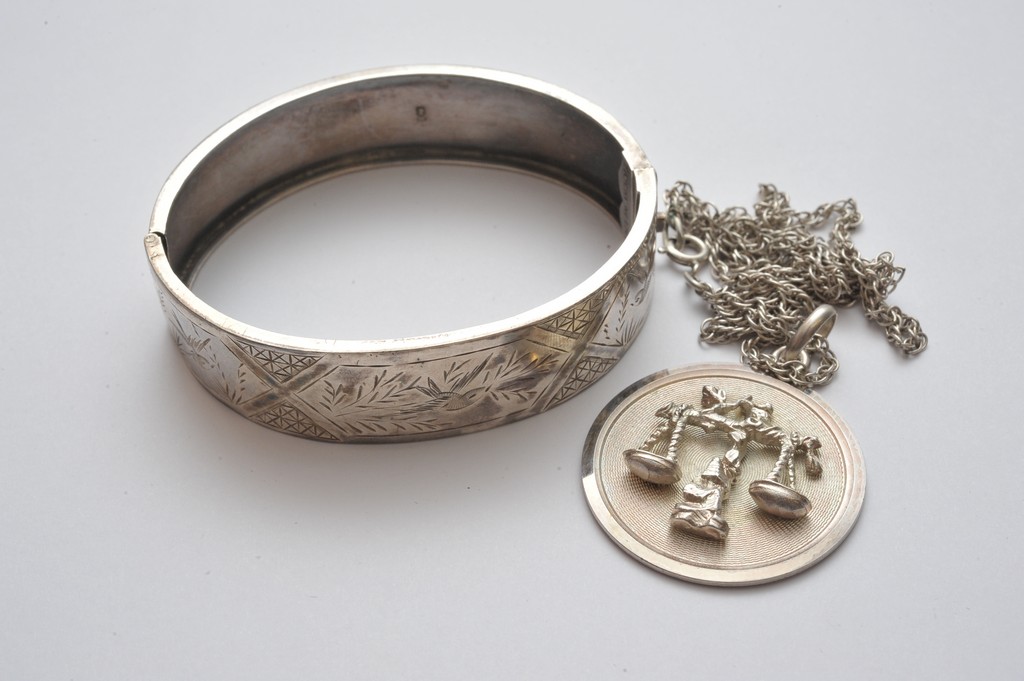 A silver bangle and a silver pendant and chain (2)