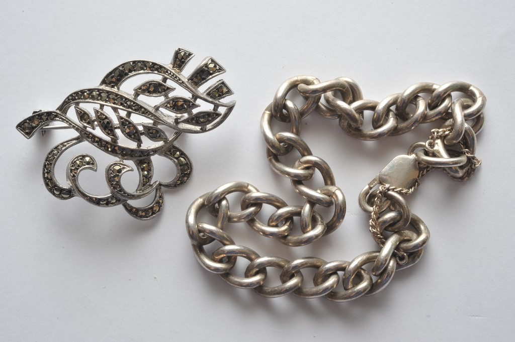 A silver bracelet and marcasite brooch