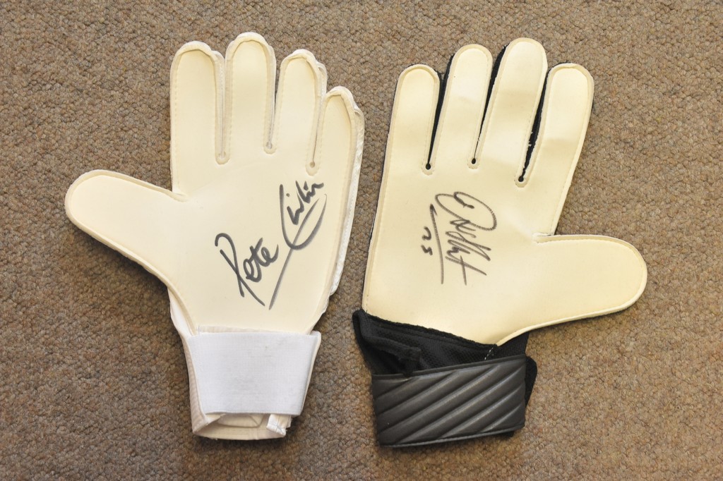 Two goal keepers gloves, one signed by Joe Hart, the other by Peter Shilton.