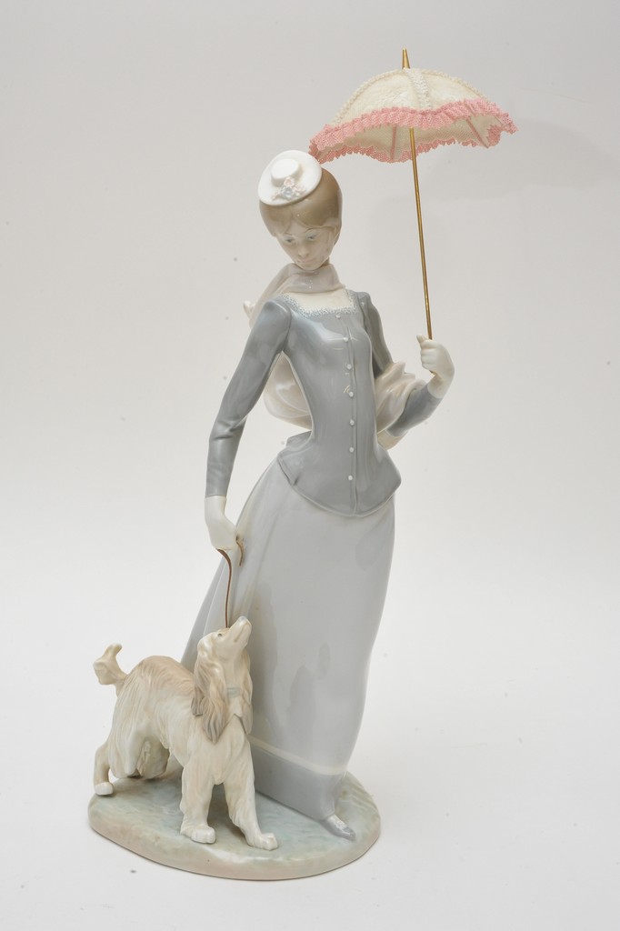 A large Lladró figure, a lady holding a parasol with a dog at her foot