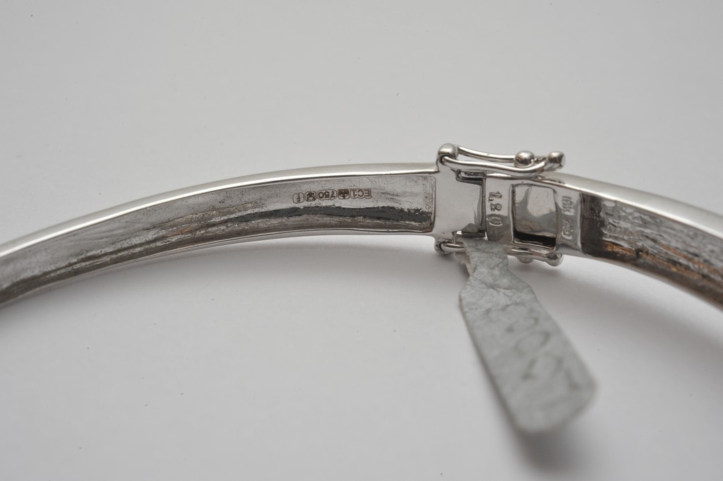 A ladies 18ct white gold bangle profusely set with round and baguette cut diamonds - Image 3 of 3