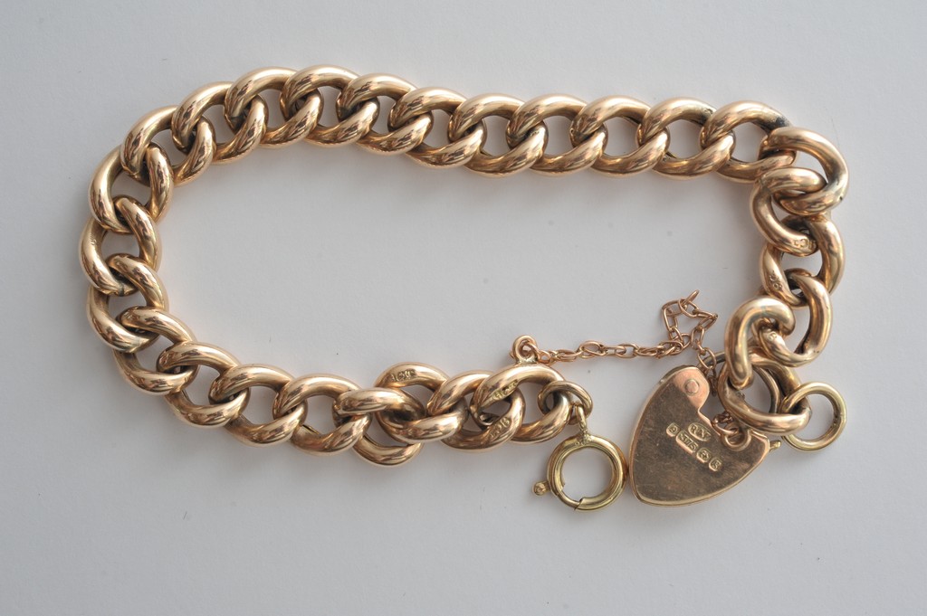 A 9ct gold bracelet with a padlock clasp